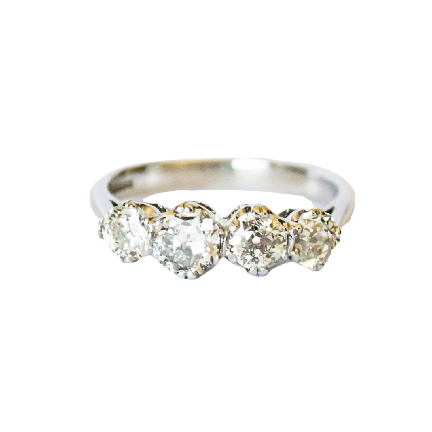 This classic ring from the 1950-1955 era is crafted in 18K gold and features diamonds. It has a weight of 4.49 grams. 
The ring is adorned with 4 old-cut diamonds, totaling 1.60 carats, with VS-SI clarity and H-J color. The diamonds are set in