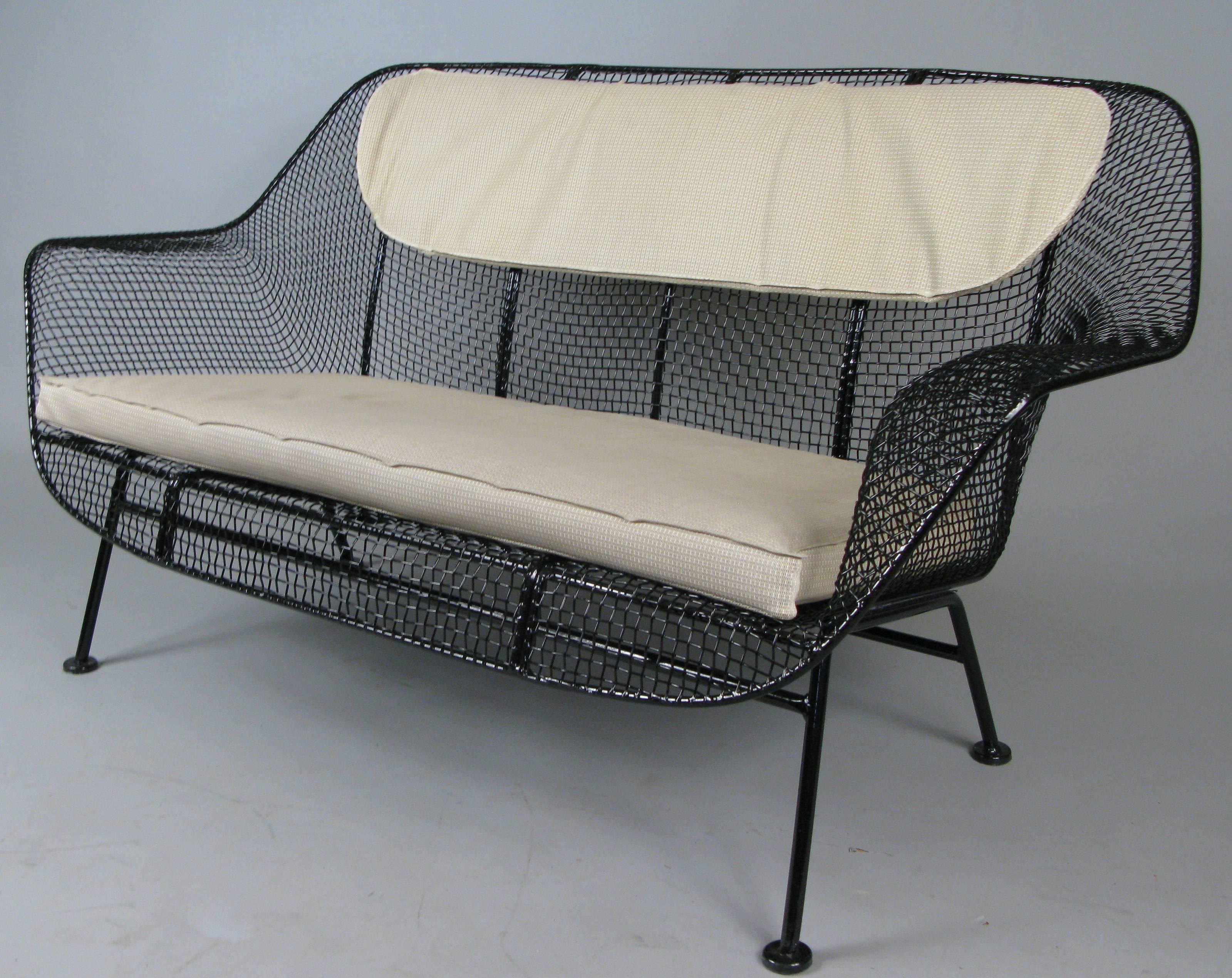 A 1950s wrought iron and steel mesh settee from John Woodard's iconic Sculptura series. Beautiful and Classic sculptural design, finished in black, but can be finished in any color you choose. Cushions not included but can be custom ordered in