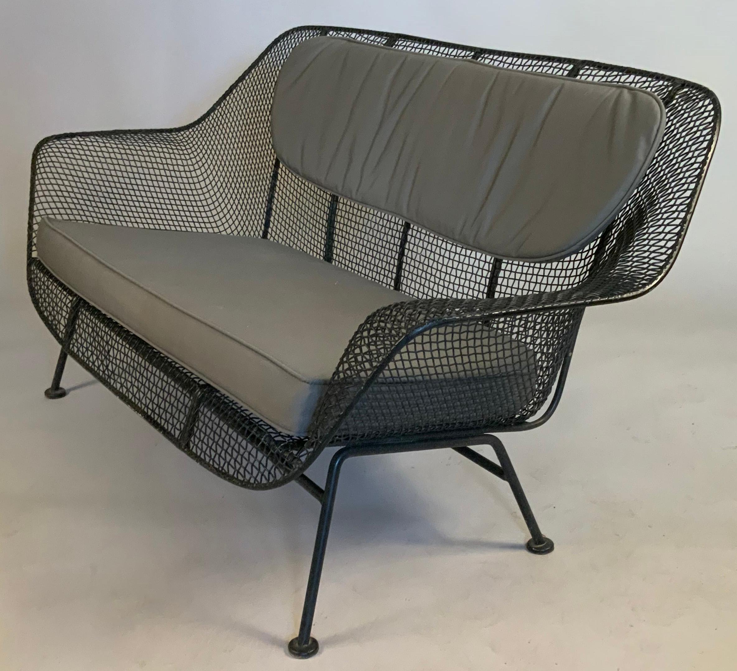 A 1950's wrought iron and steel mesh settee from Russell Woodard's iconic Sculptura series. Beautiful and Classic sculptural design, finished in black, but can be finished in any color you choose. Cushions not included but can be custom ordered in