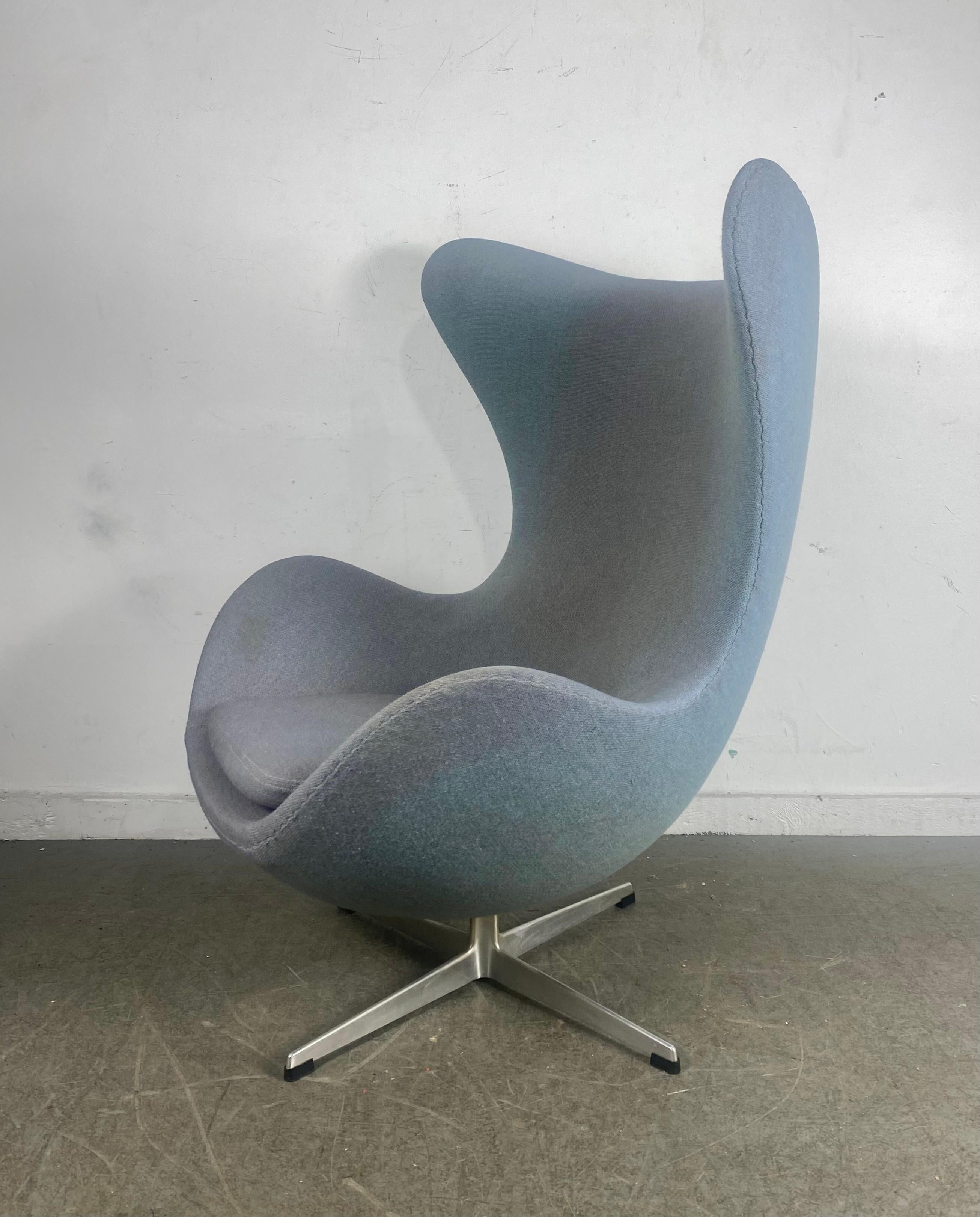 Nice early egg chair designed by Arne Jacobsen manufactured by Fritzhansen. made in Denmark.. Retains original grey/blue wool fabric in usable condition..minor fading, discoloration.Hand delivery avail to New York City or anywhere en route from