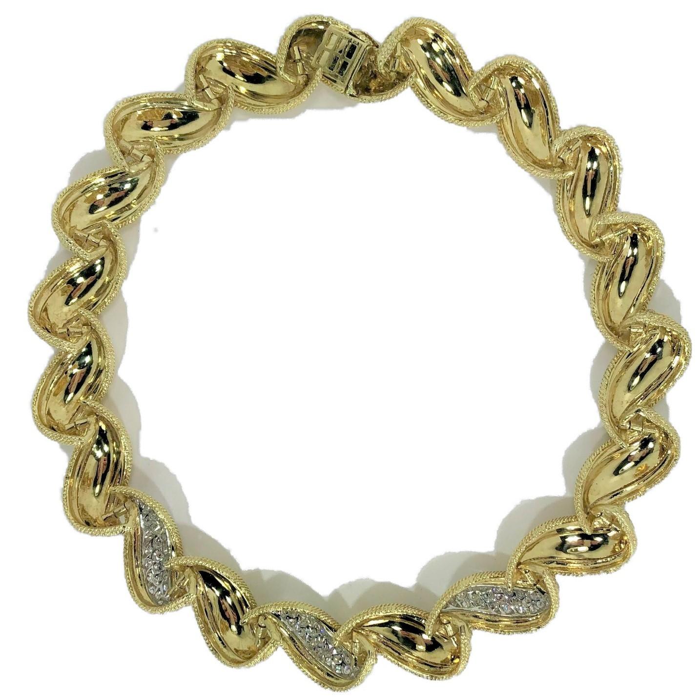 A classic 18k yellow gold and platinum 1960's choker, made up of
sixteen 3/4 inch wide bombe links with hand applied gold rope 
and with three links containing a total of 96 round diamonds set in 
platinum plates. Diamonds have a total weight of