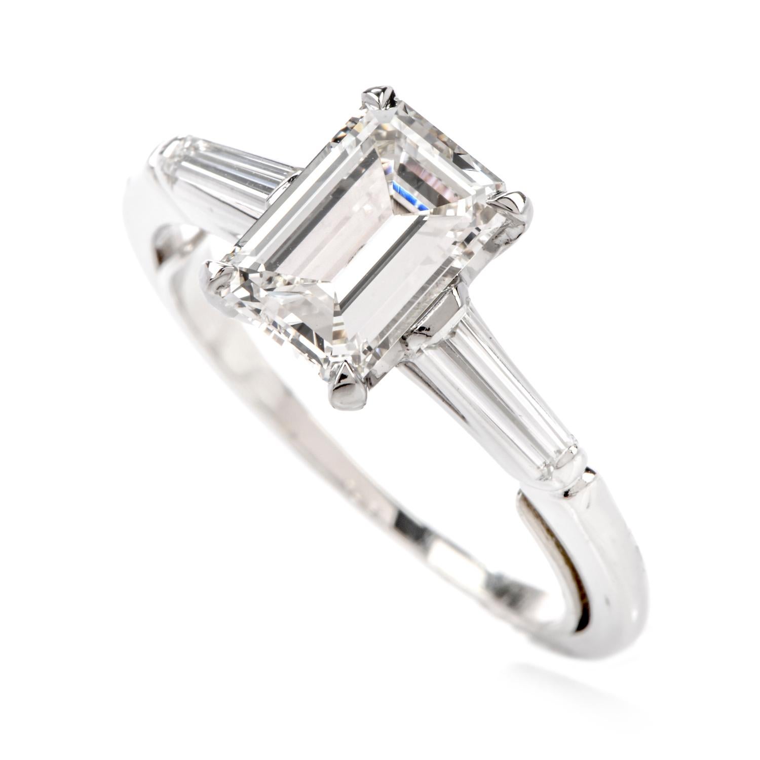 This classic 3 stone Engagement ring will help you commemorate

when 2 lives united to become one!

Crafted in Luxurious Platinum, this ring features a centered

appx. 1.41 carat Emerald cut Diamond of appx. H-I color and VS2 clarity.

Flanking from
