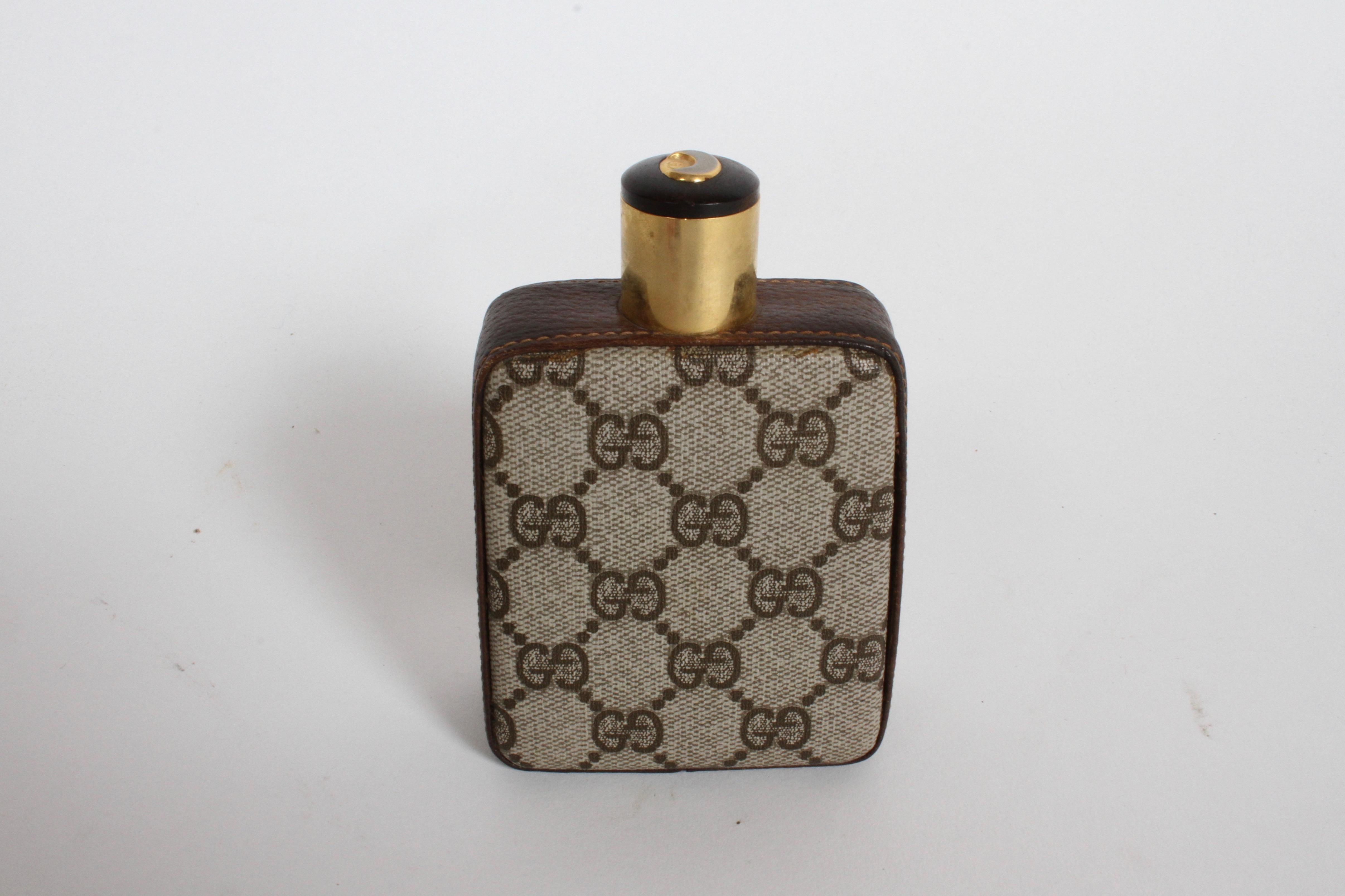 Classic 1980s Gucci Flask, made with brown leather, features Gucci's iconic double G monogram.
Stamped Gucci made in Italy. Glass liner, original gold plated cap with GG logo. Very nice original condition. Drink in style!!