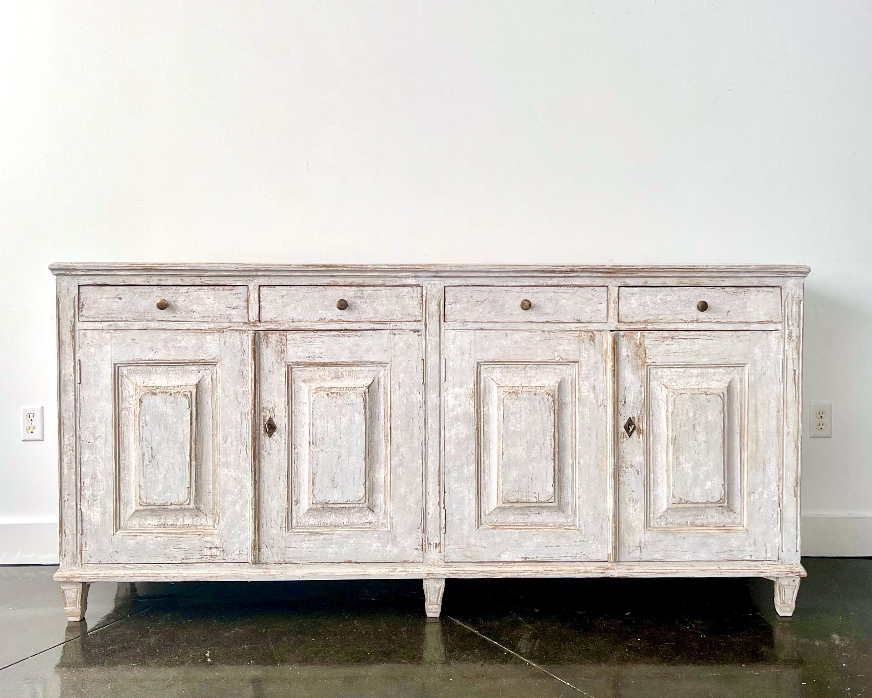 An elegant late Gustavian period four-door sideboard with four drawers over four beautifully carved and paneled doors, fitted with a brass pulls and base raised a short tapered and fluted motifs feet.
Stockholm, Sweden, circa 1840-50
Here are few