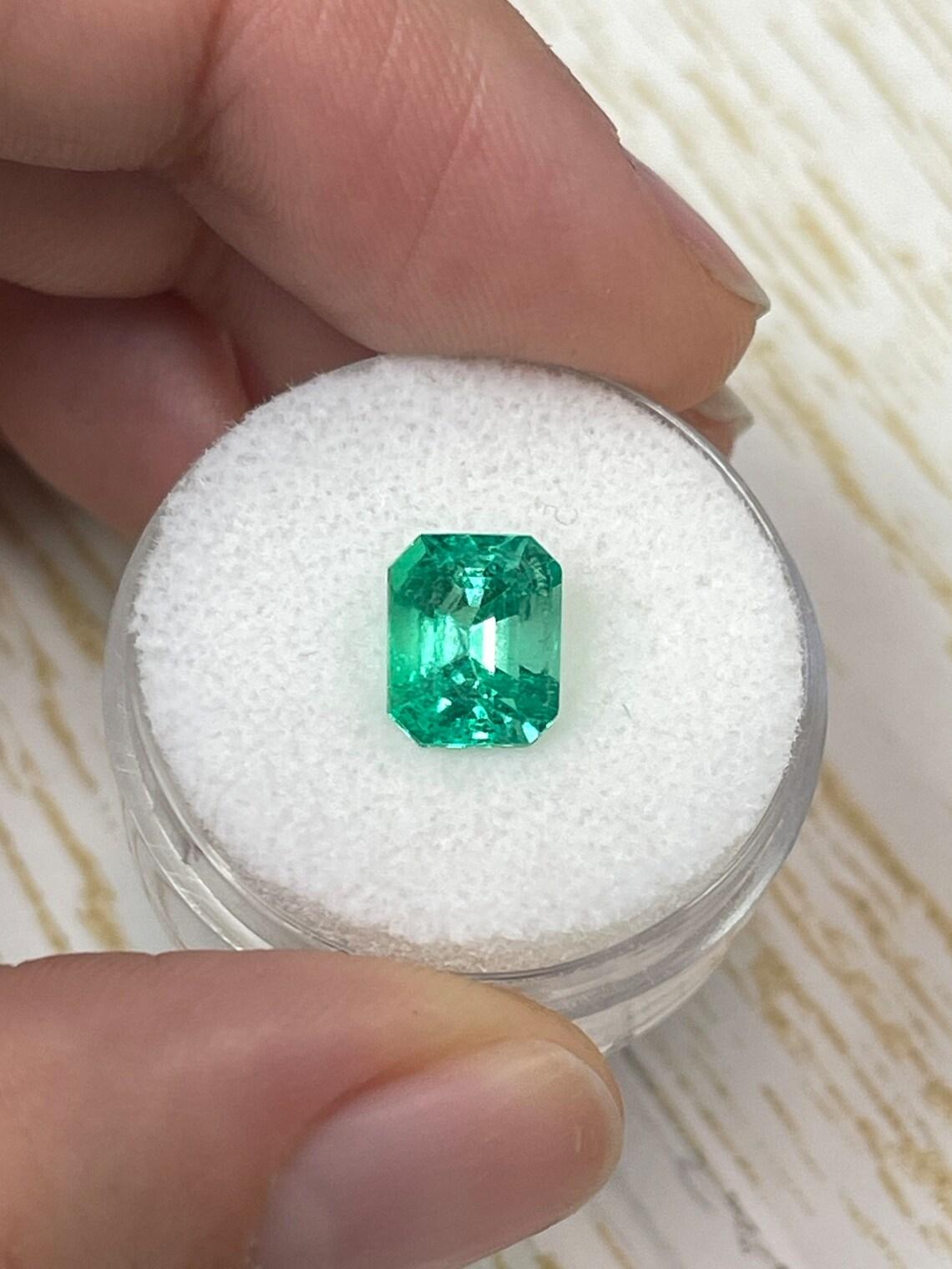 Stone: Emerald
Weight: 2.07-carats
Shape: Emerald Cut
Clarity: Transparent
Luster: Very Good
Color: Vivid Yellowish Green
Measurements: 8.69mm x 6.98mm x 5.63mm
Geographic Origin: Colombia
Treatment: Natural, Oiling

Comments: Due to their growth