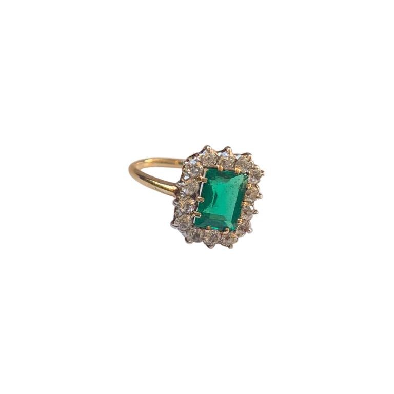 Beautiful and timelessly classic, ladies vintage custom hand made 14 Karat yellow gold ring features in the center one approximately 1.68 carat Columbian emerald cut vivid green emerald, measuring approximately 8.80mm x 6.80mm x 3.80mm. The emerald