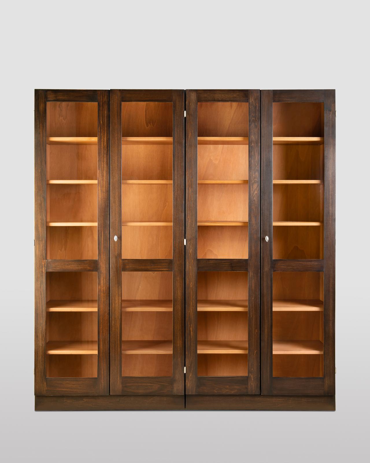 Rustic yet elegant, this four-door, modular bookcase flaunts a clean and sober shape typical of Nordic design. Equipped with twelve internal shelves adjustable in height, it is handcrafted following refined techniques adding to its unrivaled artisan