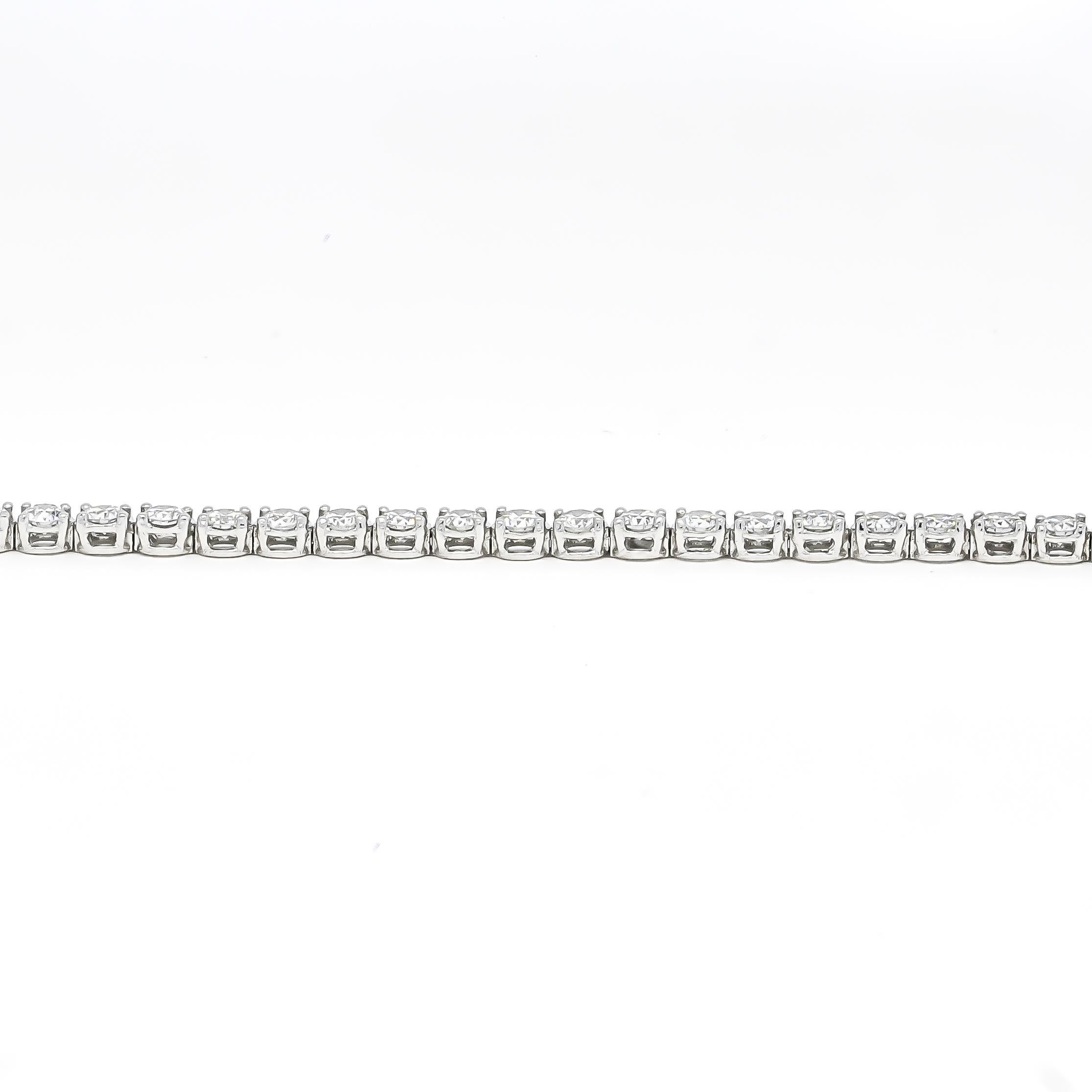 Indulge in the timeless allure of this classic 4.00 carat four-prong tennis bracelet. Meticulously crafted in 18K white gold, it embodies elegance and sophistication. Each natural diamond, meticulously selected for its exceptional quality, is