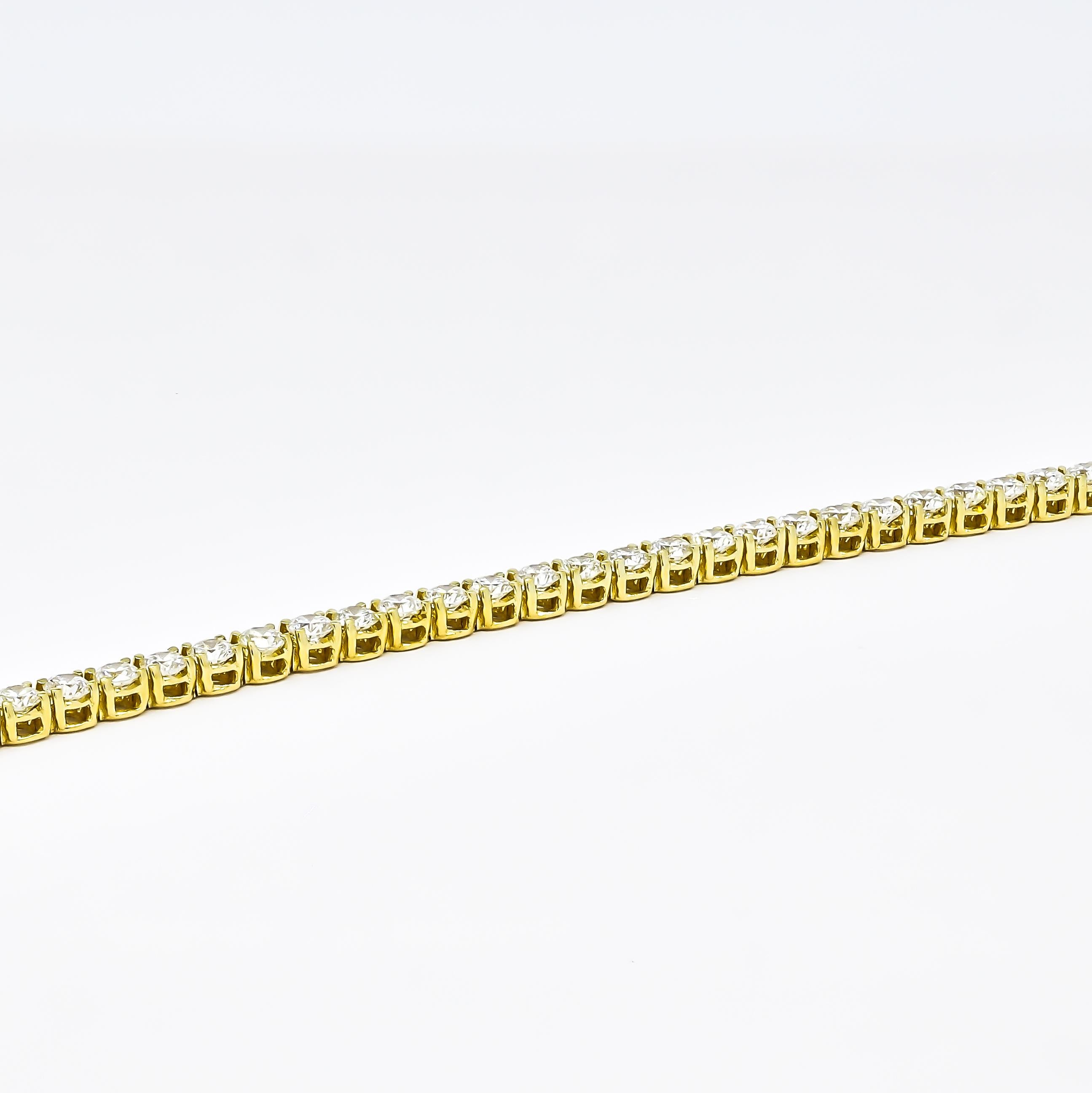 Indulge in the timeless allure of this classic 4.00 carat four-prong tennis bracelet. Meticulously crafted in 18K yellow gold, it embodies elegance and sophistication. Each natural diamond, meticulously selected for its exceptional quality, is