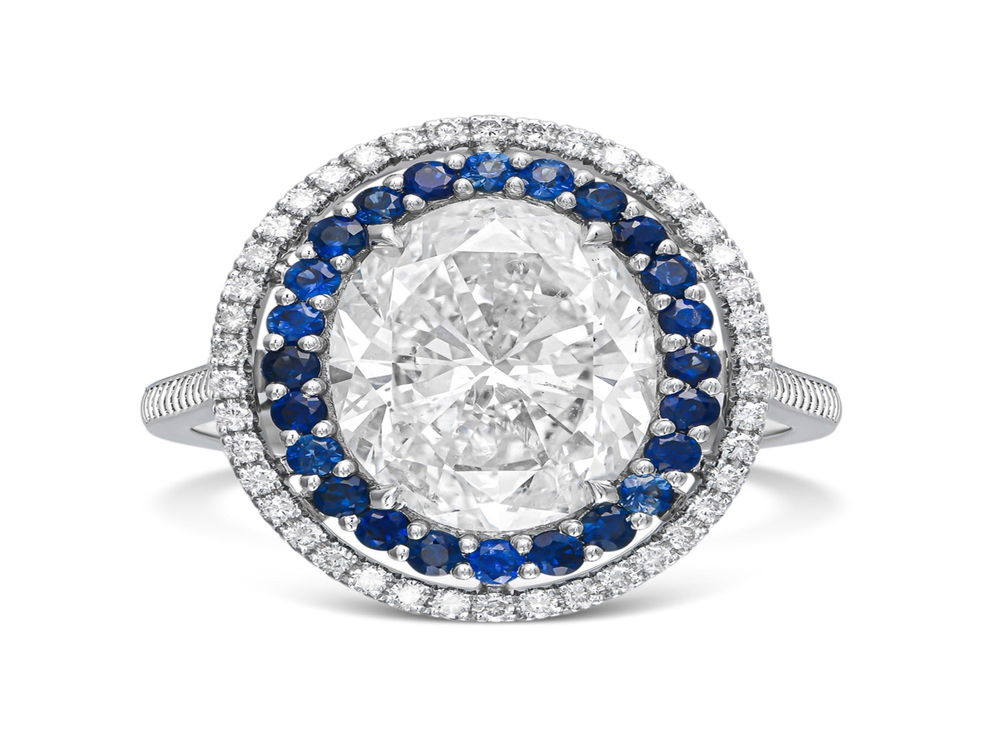 Modern Classic 5 carat oval cocktail ring , diamonds and blue sapphire For Sale