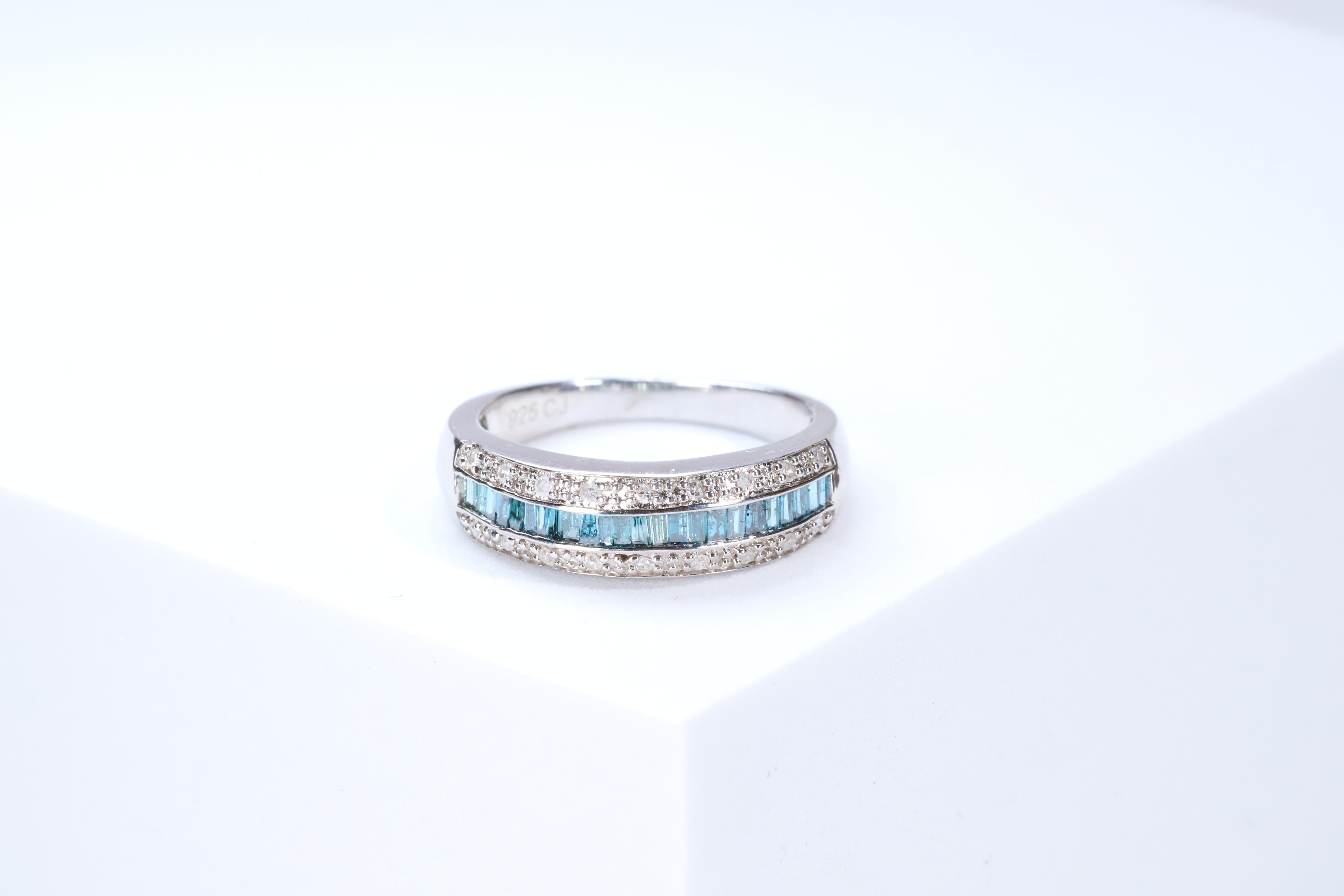 Stunning, timeless and classy eternity Unique Ring. Decorate yourself in luxury with this Gin & Grace Ring. The 925 Sterling Silver jewelry boasts with Natural Round-cut white Diamond (18 Pcs) 0.10 Carat, Baguette-cut Blue Diamond (25 pcs) 0.37