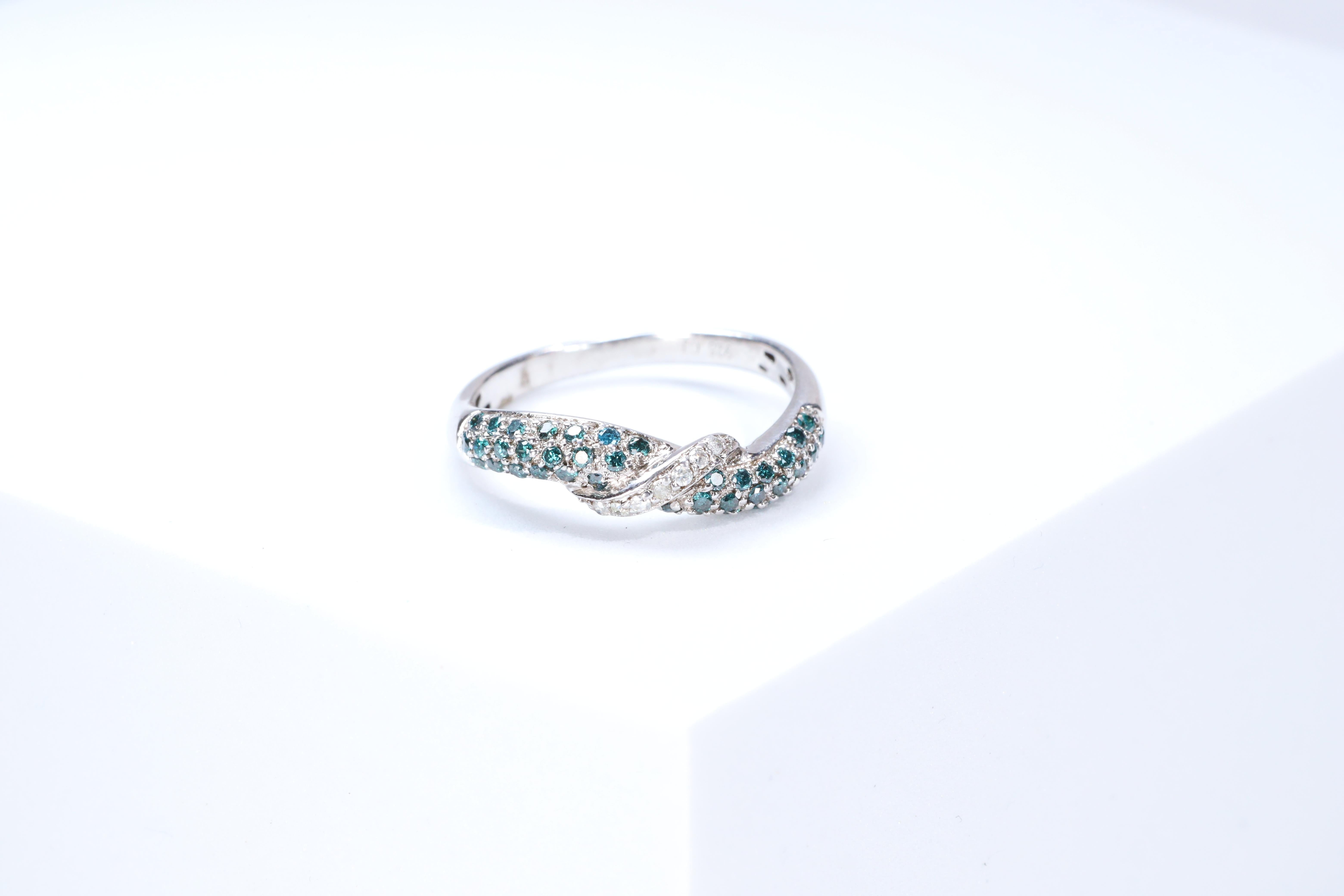 Stunning, timeless and classy eternity Unique Ring. Decorate yourself in luxury with this Gin & Grace Ring. The 925 Sterling Silver jewelry boasts with Natural Round-cut white Diamond (7 Pcs) 0.04 Carat, Round-cut Blue Diamond (40 pcs) 0.32 carat