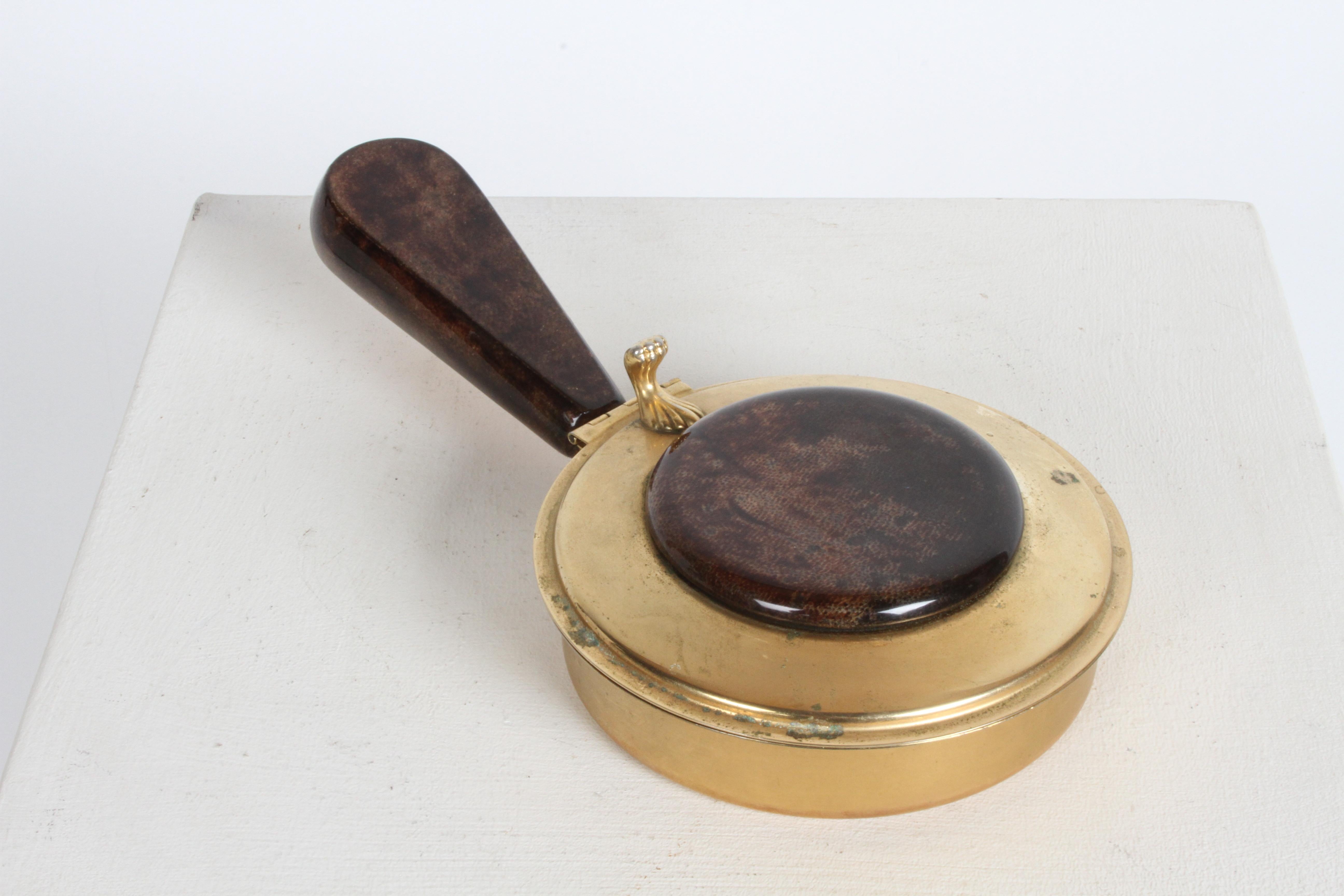 Mid-Century Aldo Tura Italy silent butler or crumb catcher in 24k goldt plate with lacquered goatskin parchment. Hard to find silent butler, classic Tura's style with the lacquered goatskin lid top and chunky handle. Wear / patina to 24k gold plate,