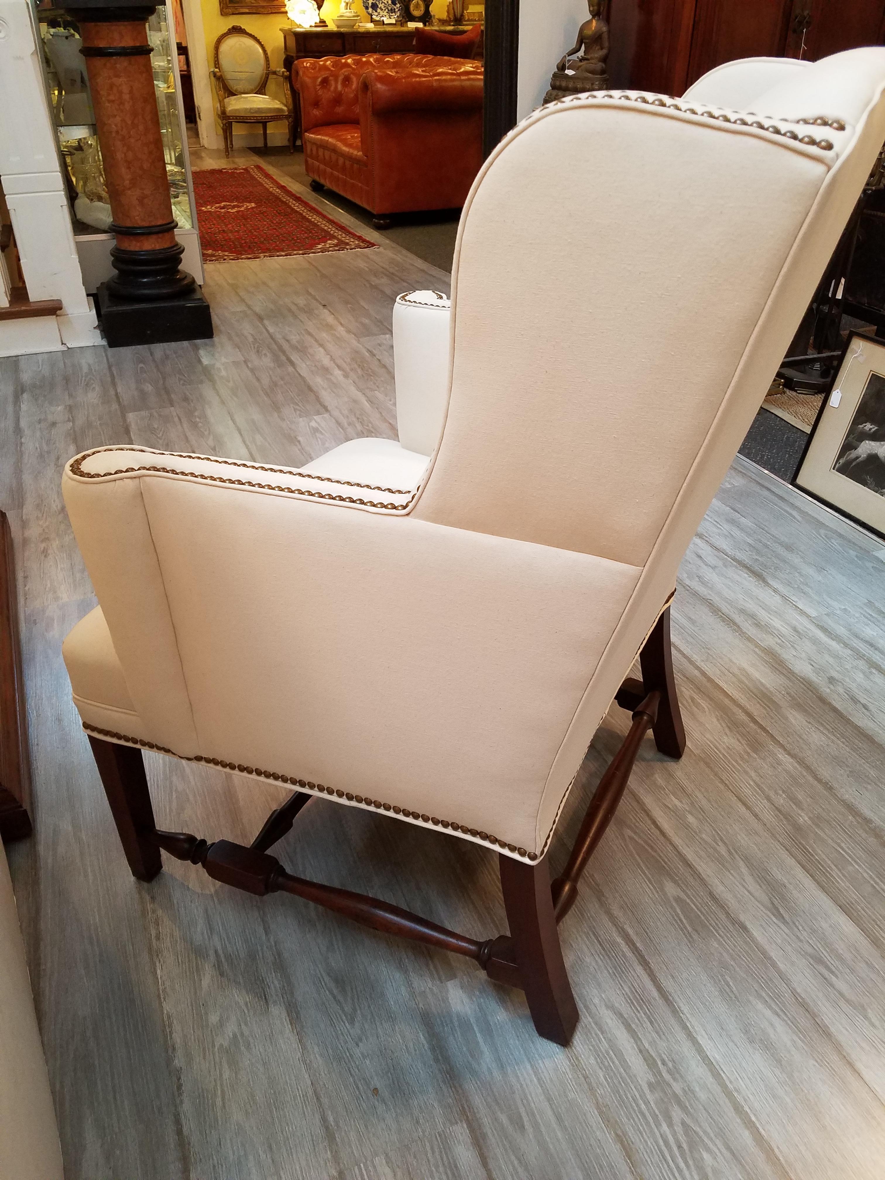 Classic American Wing chair with turned walnut stretchers. Highest quality solid wood frame with 8 way hand tied springs. Superior quality upholstery in new white duck fabric, circa 1900.
Measures: 32 W x 28 D x 41 H. Seat height 22.