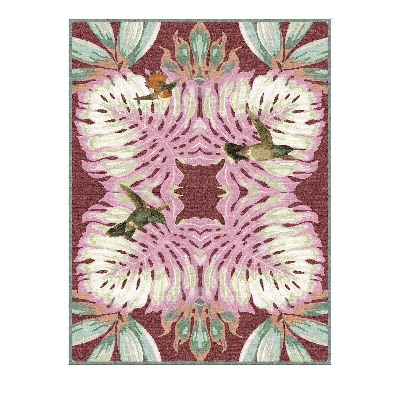 A charming and sophisticated work of art, this hand knotted rug is a kaleidoscope of colors and motifs. The psychedelic array of green leaves and white palms outlined in bright pink form an intricate, mirrored image set against a deep fuchsia
