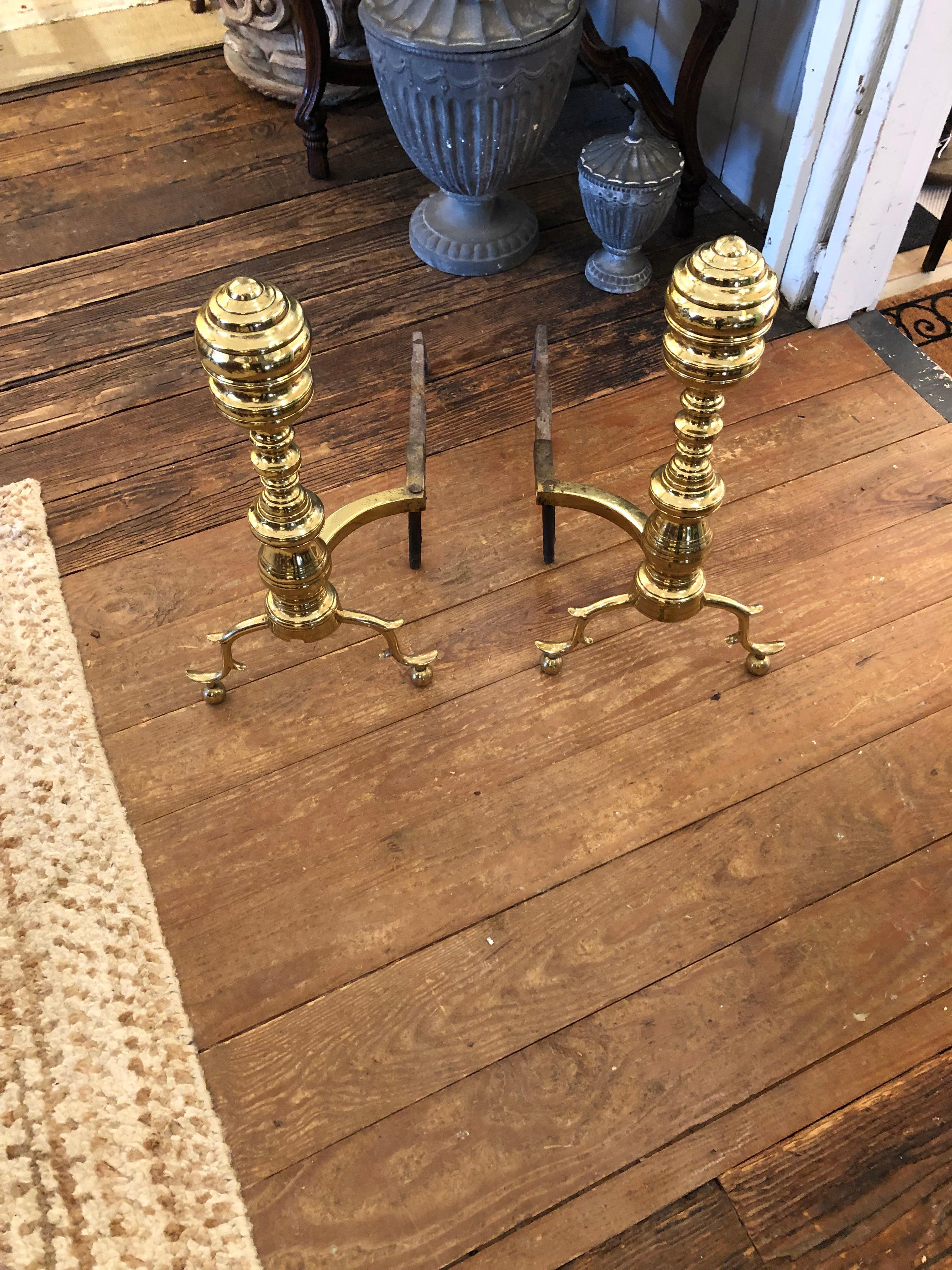 Classically elegant large beehive style Chippendale andirons in polished brass.