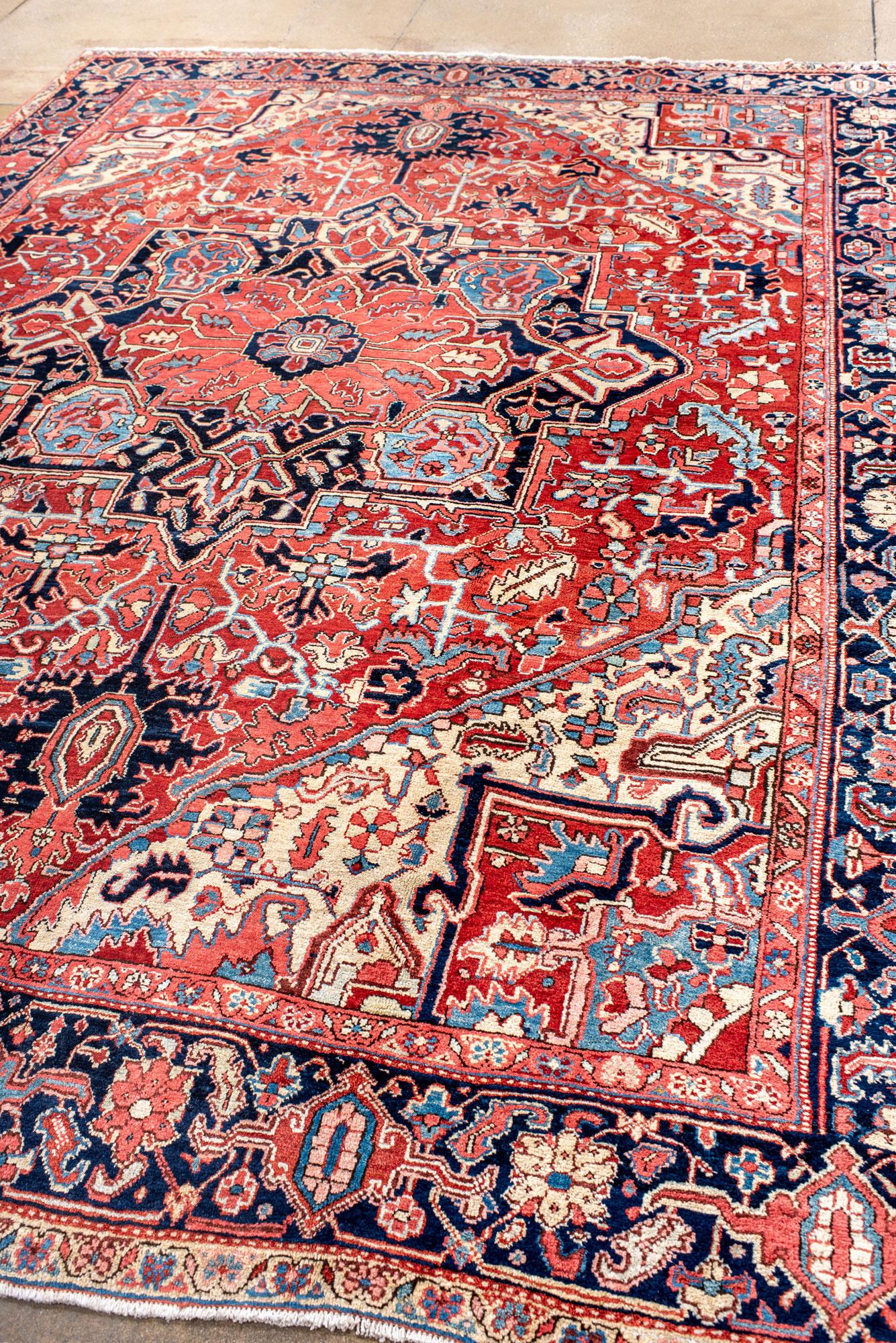 Persian Classic Antique Heriz Carpet with a Red Field and Blue Accents For Sale