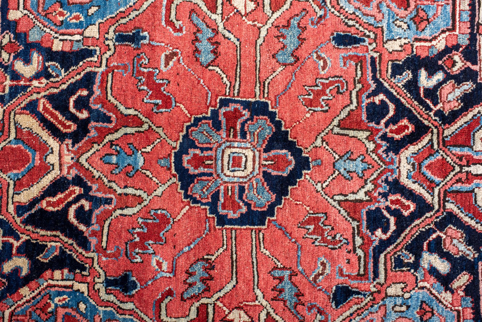 Hand-Knotted Classic Antique Heriz Carpet with a Red Field and Blue Accents For Sale