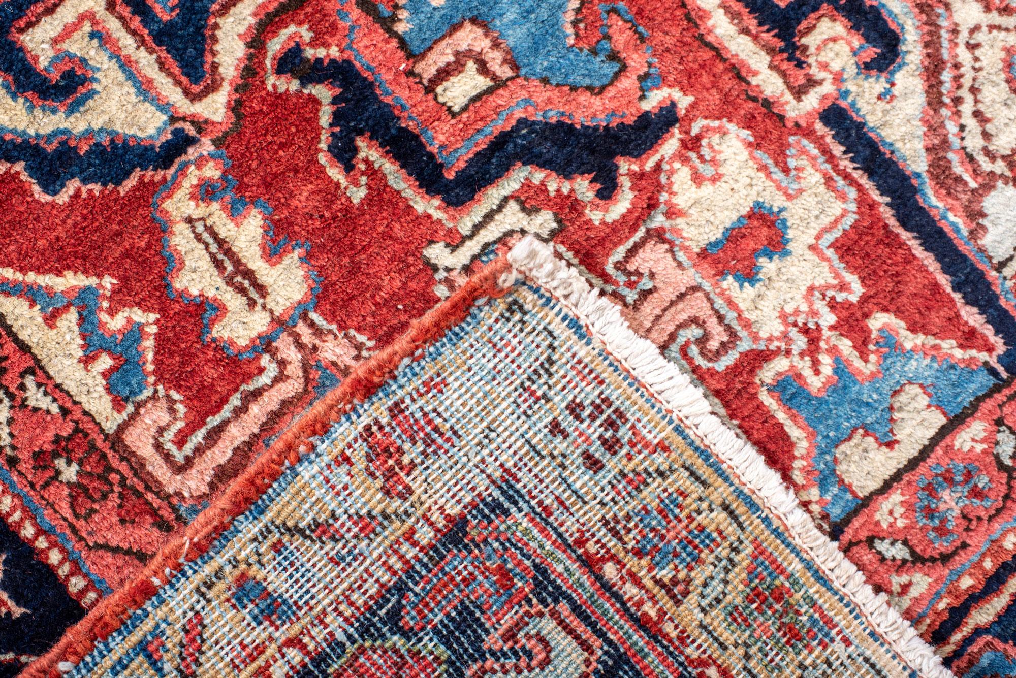 20th Century Classic Antique Heriz Carpet with a Red Field and Blue Accents For Sale