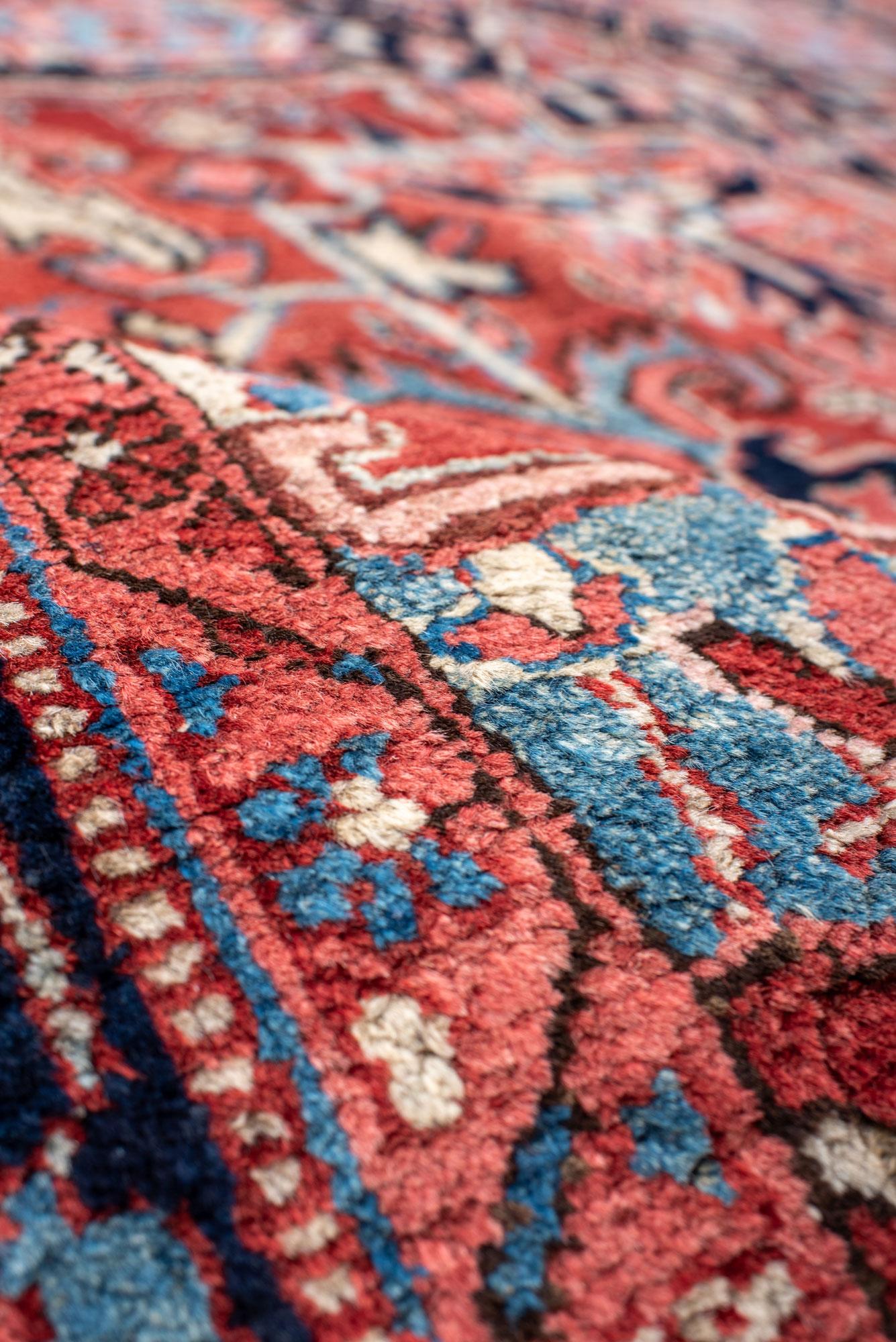 Wool Classic Antique Heriz Carpet with a Red Field and Blue Accents For Sale