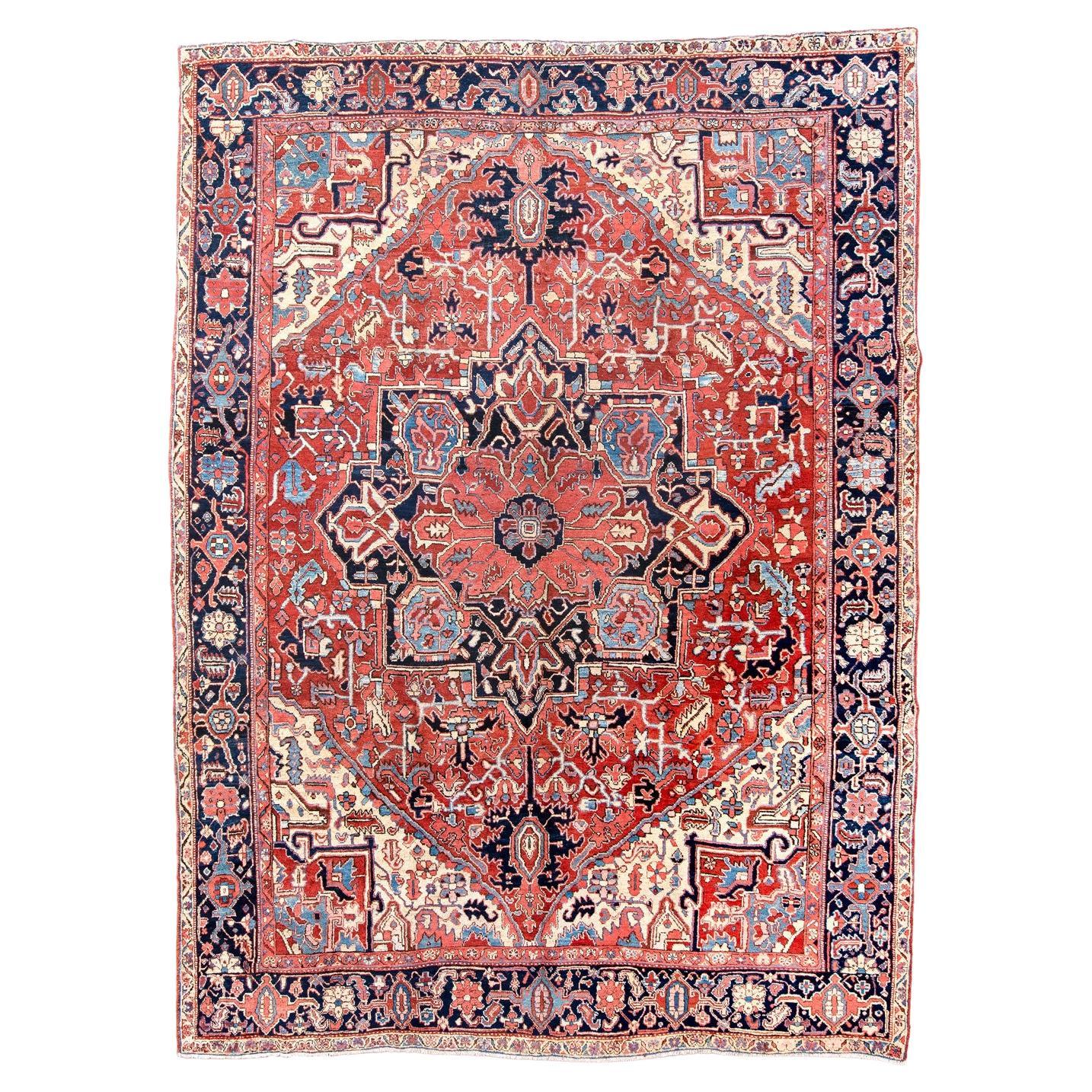 Classic Antique Heriz Carpet with a Red Field and Blue Accents For Sale