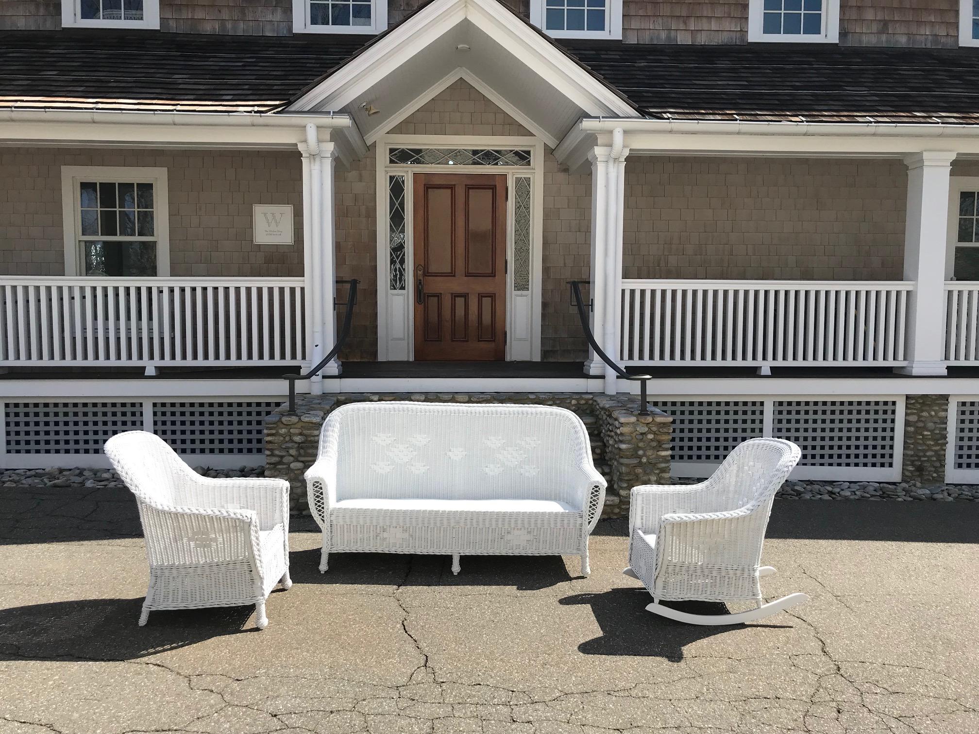 This is a classic antique Heywood Wakefield Wicker set from the 1920s in fresh white paint. Additional pieces from this suite are available under separate listings. Sofa measures 74