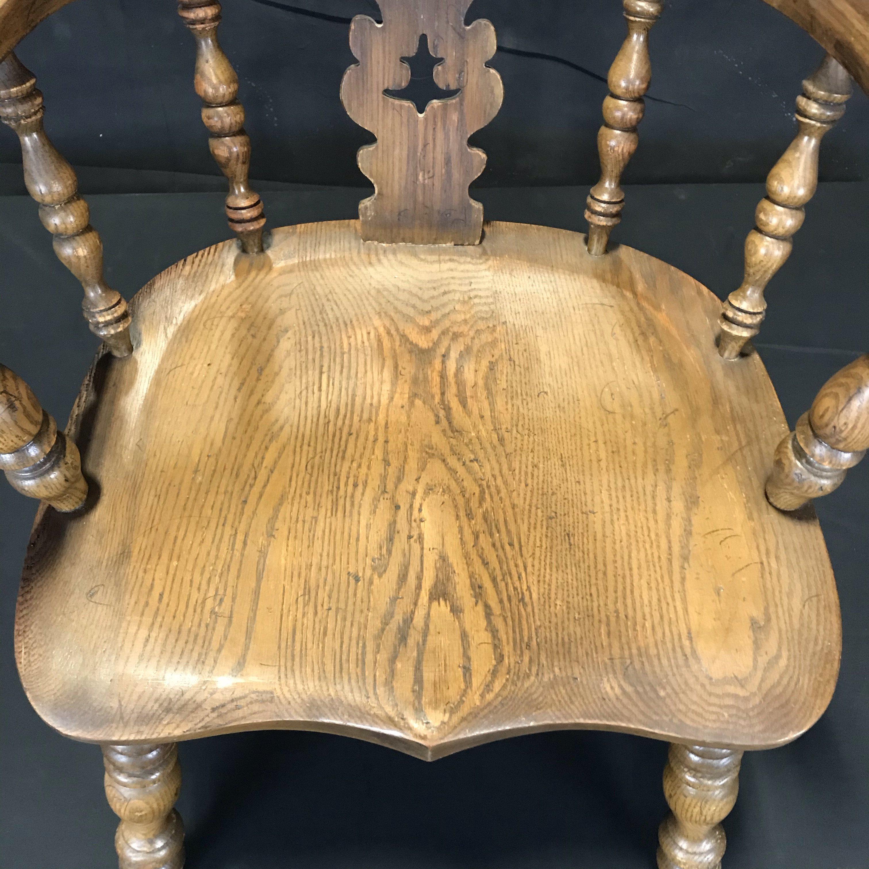 Early 20th century oak Windsor armchair with turned legs and stretcher, well figured and very comfortable. The Windsor chair is established as one of the great classics of English country furniture. Made by village craftsmen to traditional designs