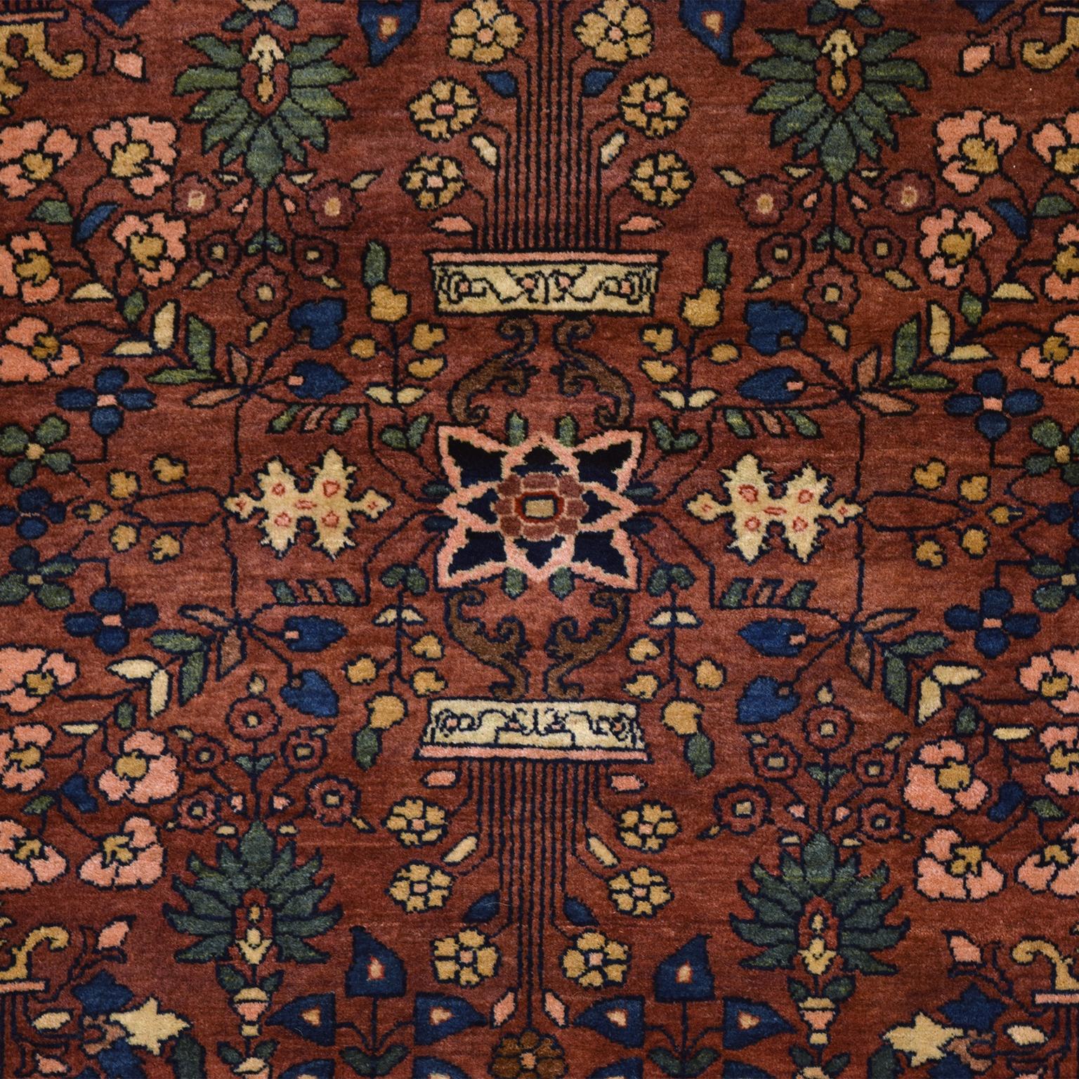 This antique 1880s Persian Farahan rug featuring a Sarouk design was created using pure handspun wool and organic vegetable dyes. The classic Sarouk pattern incorporates an array of flowers, butterflies, and potted plant motifs, completed in hues of