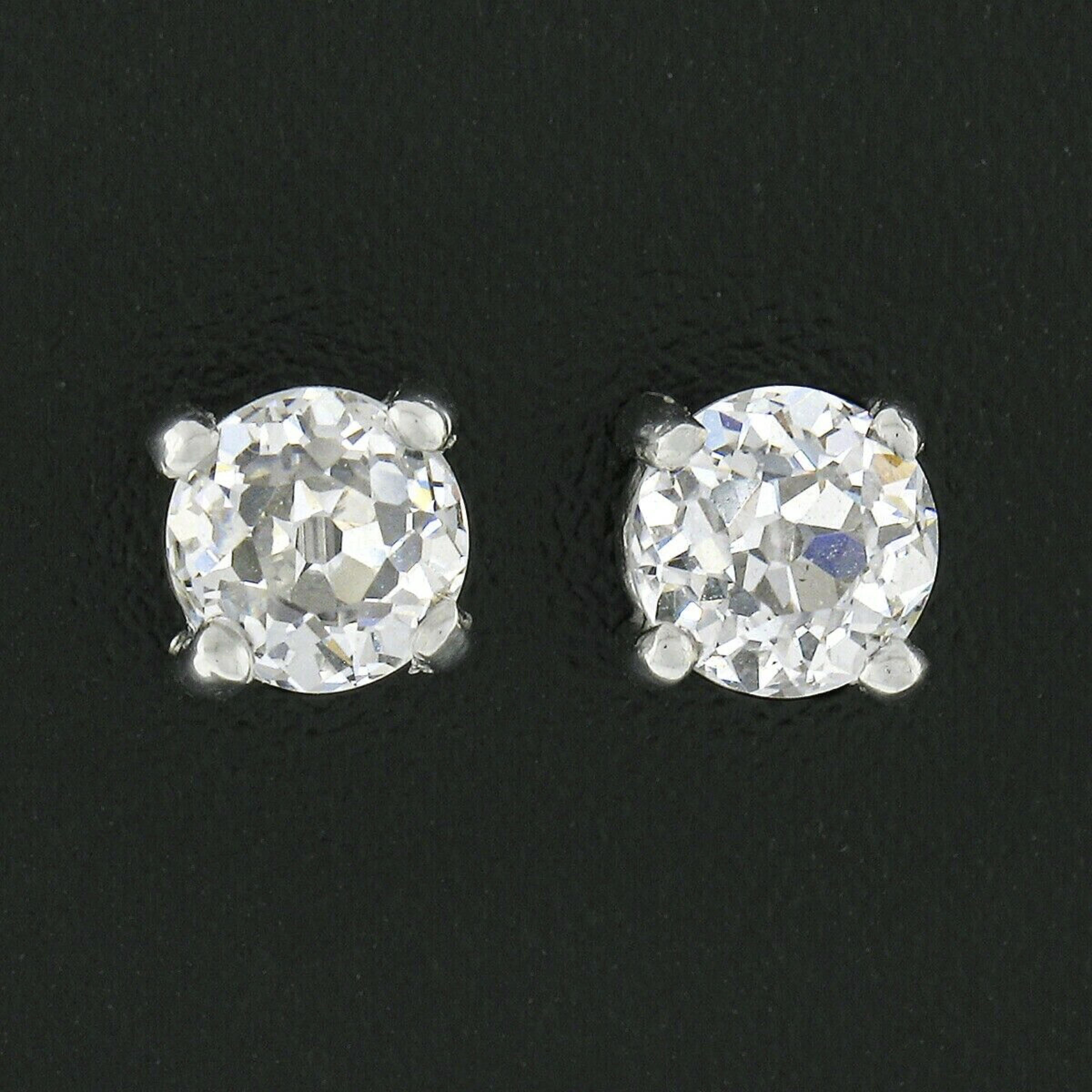 Here we have an outstanding pair of classically styled diamond stud earrings. They feature a pair of genuine, antique, diamonds that are each GIA certified with an old European cut, weighing a total of exactly 1 carat in weight, and are