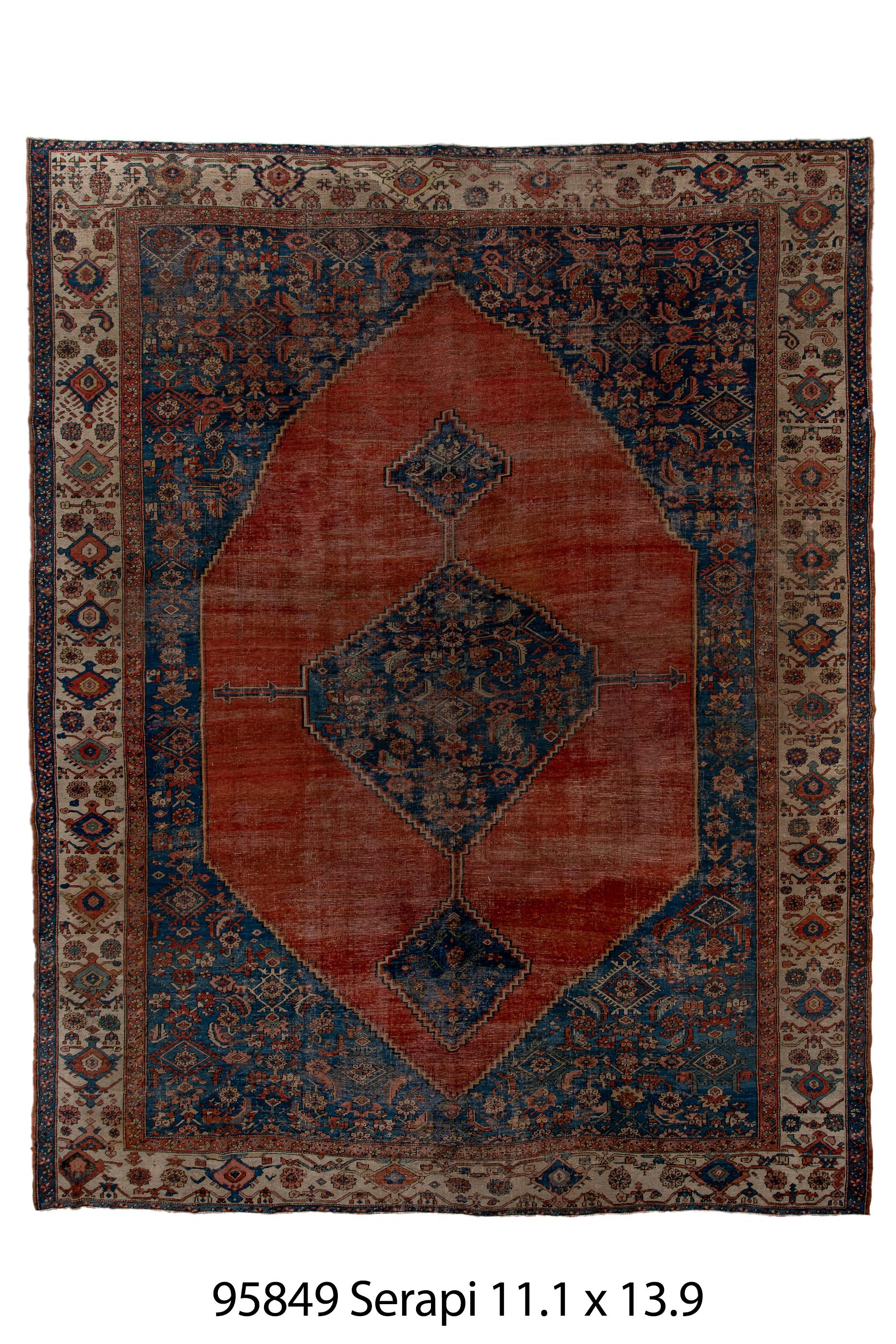 The surrounding medium blue Herati field host a plain madder red hexagonal subfield cenred on a blue Herati medallion.  Stepped blue diamond pendants. Ivory strip style main border with partially fringed palmettes in chains. A very attractive carpet