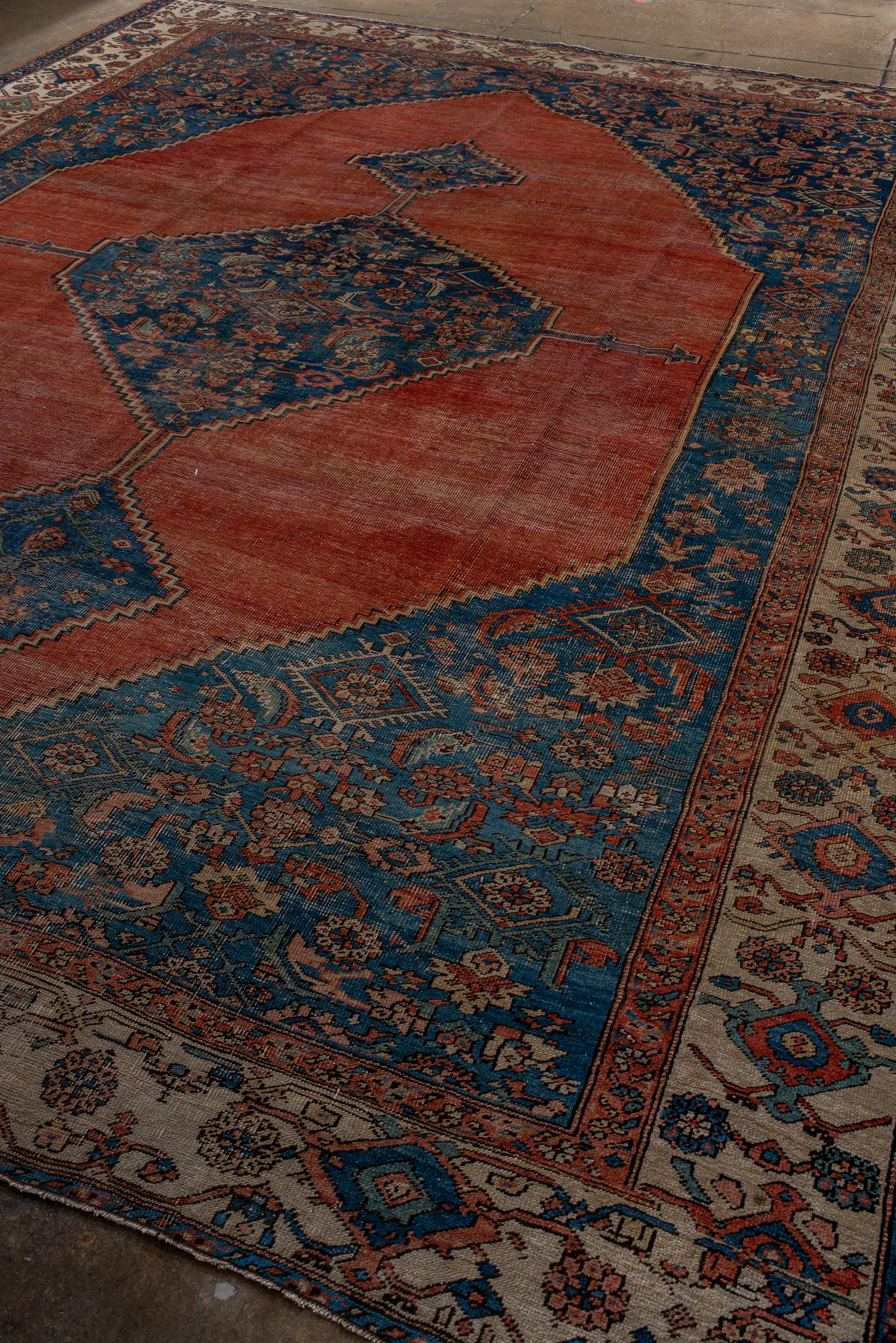 Persian Classic Antique Serapi with a Blue and Red Field and a Blue Medallion  For Sale