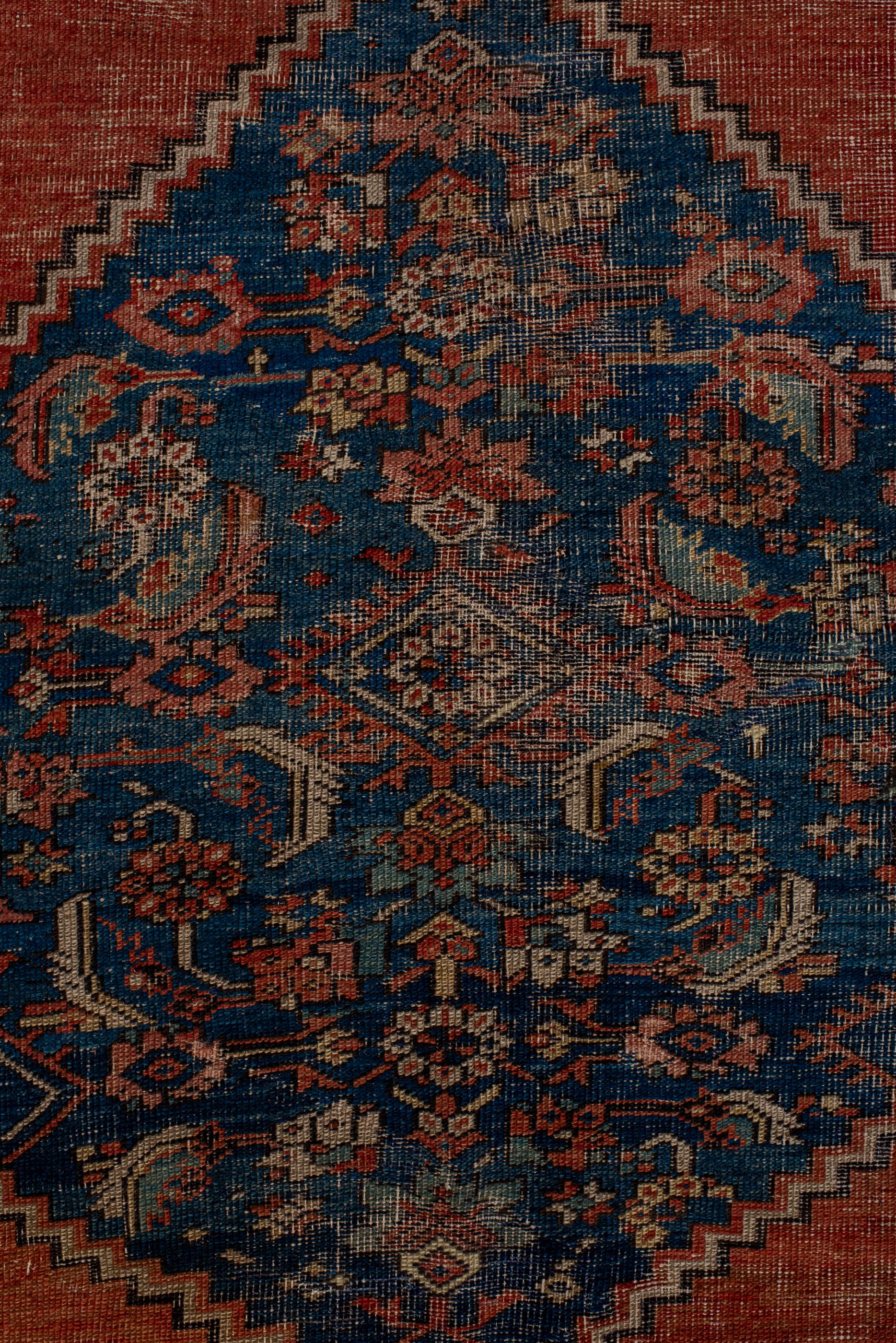 Hand-Knotted Classic Antique Serapi with a Blue and Red Field and a Blue Medallion  For Sale