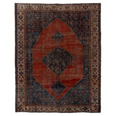 Classic Antique Serapi with a Blue and Red Field and a Blue Medallion 