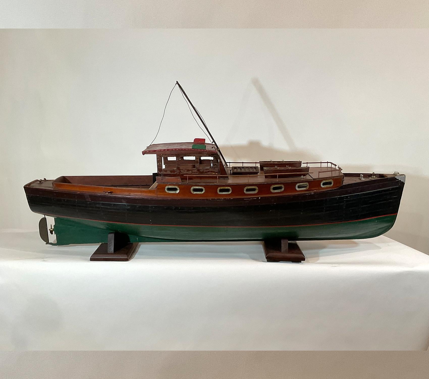 Antique model of the cabin cruiser “Waco”. Planked hull and deck. Great cabin work with portholes, flag, helm, benches, etc. Classic yacht model with great character. Big and beautiful classic Americana.

Weight: 25 LBS
Overall Dimensions: 28” H