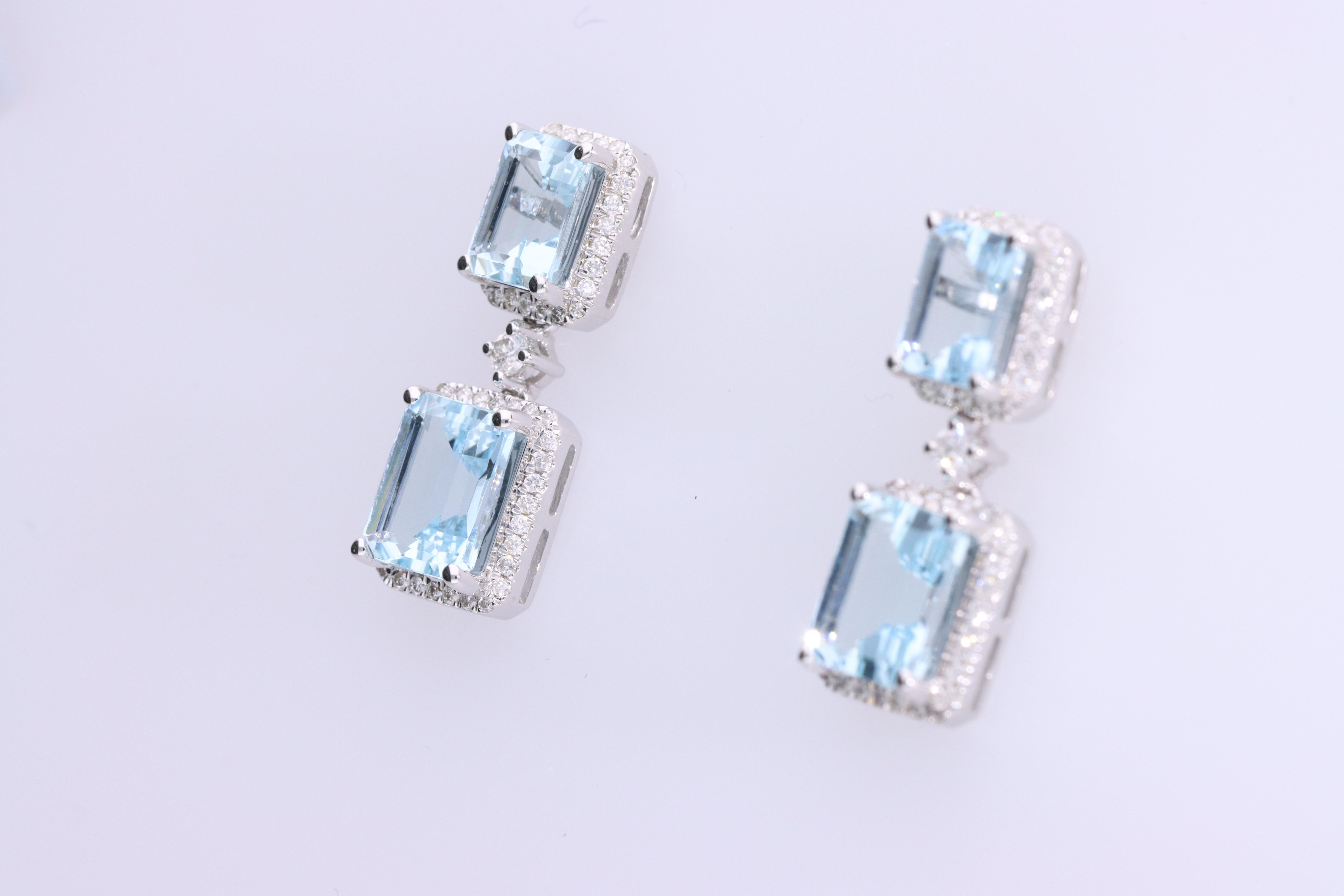 Each of these pretty earrings from Gin & Grace features a Aquamarine gemstone on a lever back clasp adorned with white diamonds. These earrings are made of rich 14-karat White gold with a high polish. Style: Dangle, Gemstone Cut : Emerald-cut Total