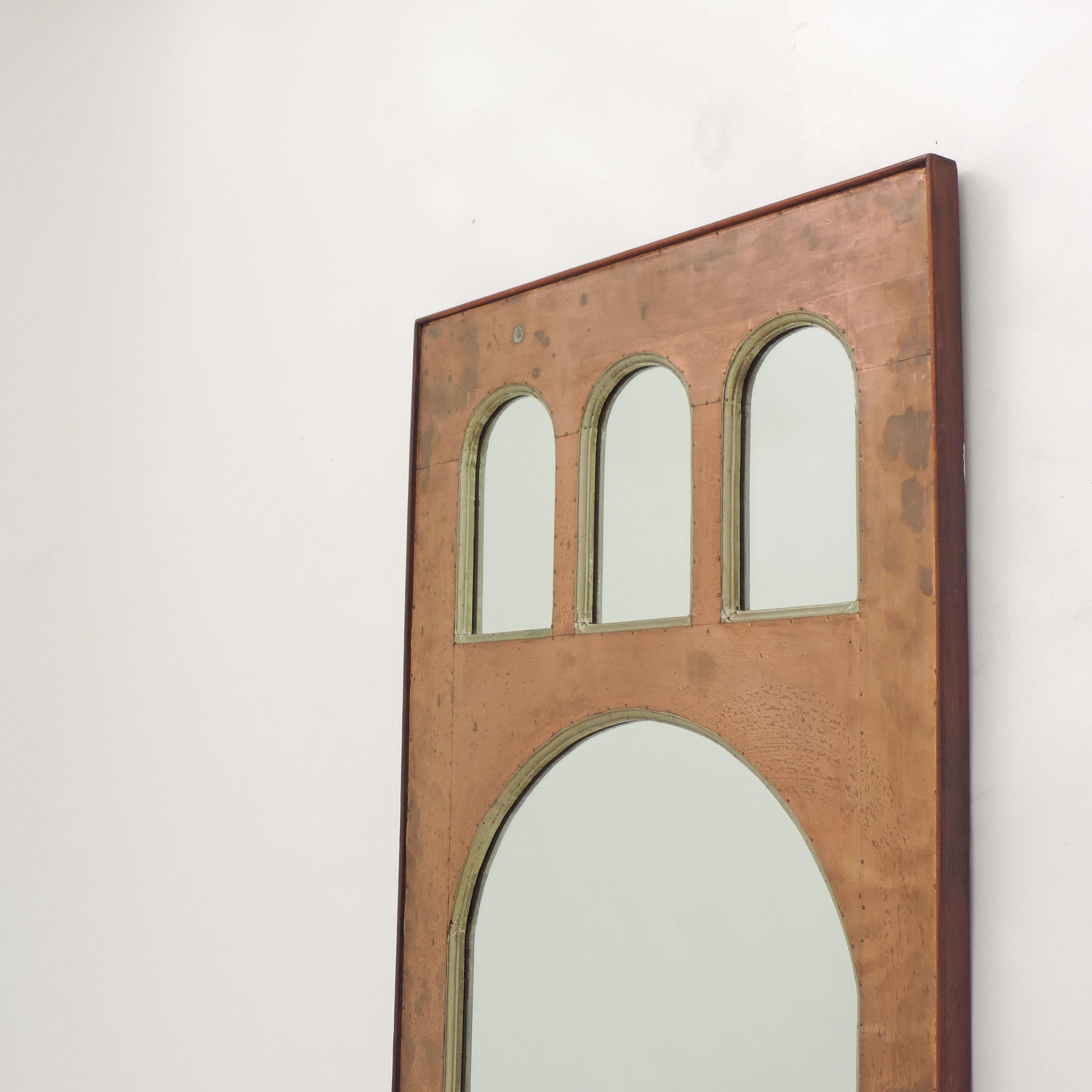 Splendid Pontiesque classical Italian Metaphysical 1950s-1960s copper wall mirror.
Hammered copper and aluminum sheets on wood.
Attributed to Lorenzo Burchiellaro.
  