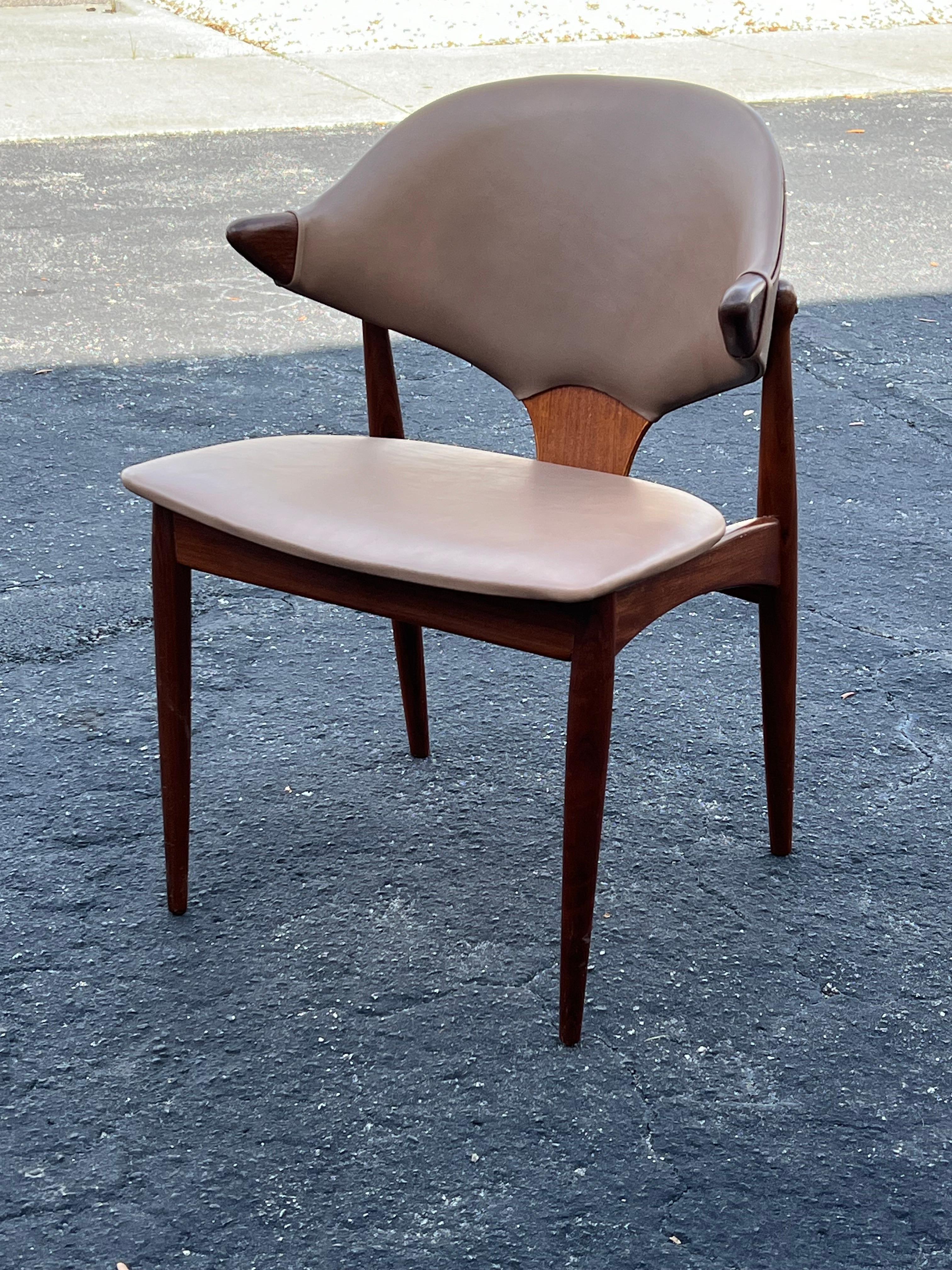 A Classic and funky chair designed by Arne Voder (Denmark) and manufactured in Holland circa 1964. Sculptural teak  frame newly reupholstered in brown leather. Perfect as a desk or occasional chair-looks great from every angle.
The arms are 25.75