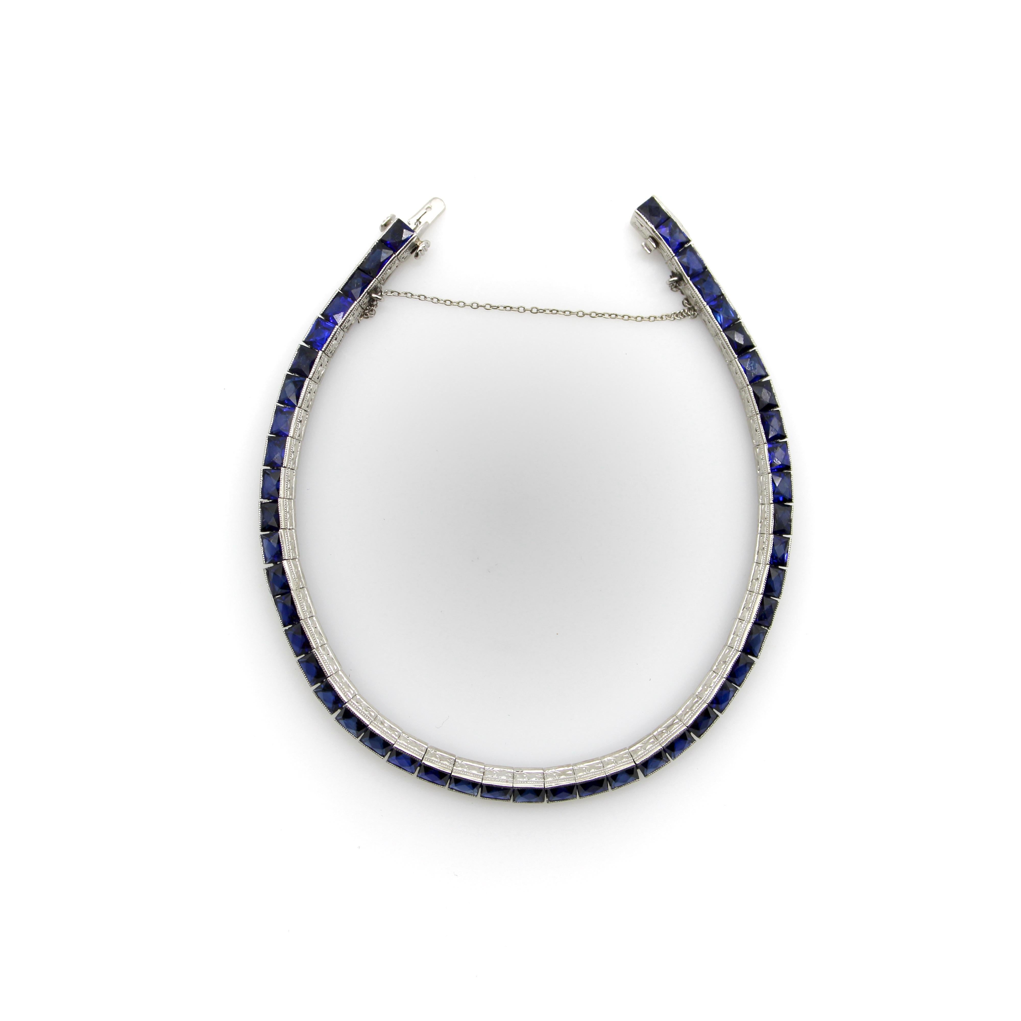 This platinum bracelet is a classic Art Deco design, with a fluid line of French Cut sapphires channel set to create a myriad of sparkle. The sapphires have beautiful shades of deep blue, and the facets of the French cut throw off a lot of shine—the