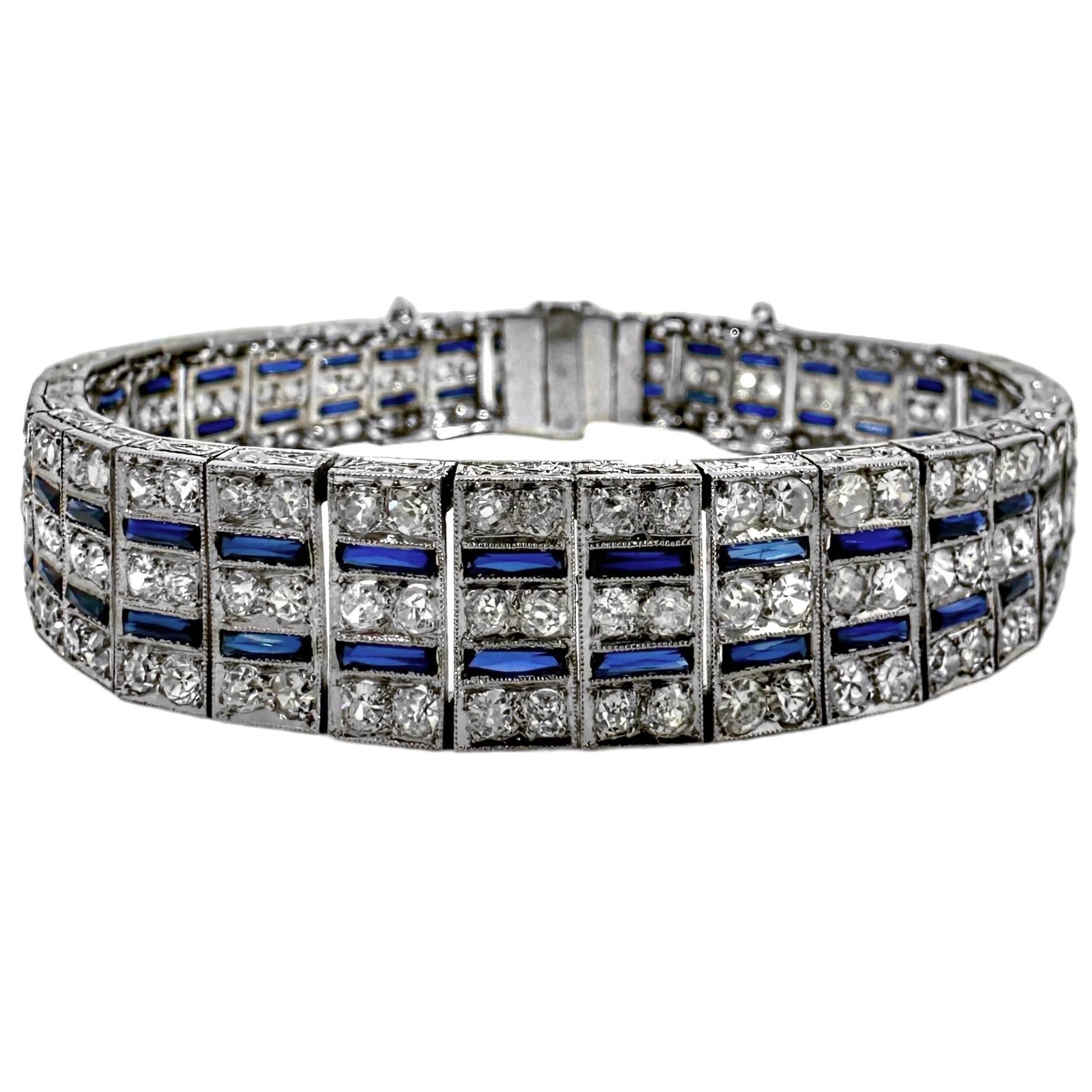 This original Art-Deco period 1/2 inch wide platinum bracelet is set with a total of 210 antique single cut diamonds and with two lines of verneuil  process synthetic blue sapphires*. Total approximate diamond weight is  6.50ct and overall diamond