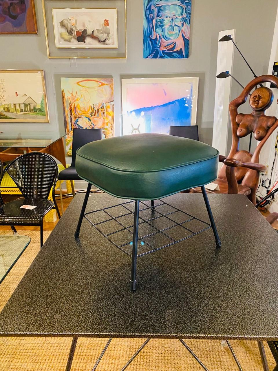 Incredible piece of atomic midcentury design. This beautiful foot stool represents the iconic atomic design of the 1960s. A pleather resting base in a beautiful green shade is balanced over streamlined legs. Mid Century and Atomic in style but oh so