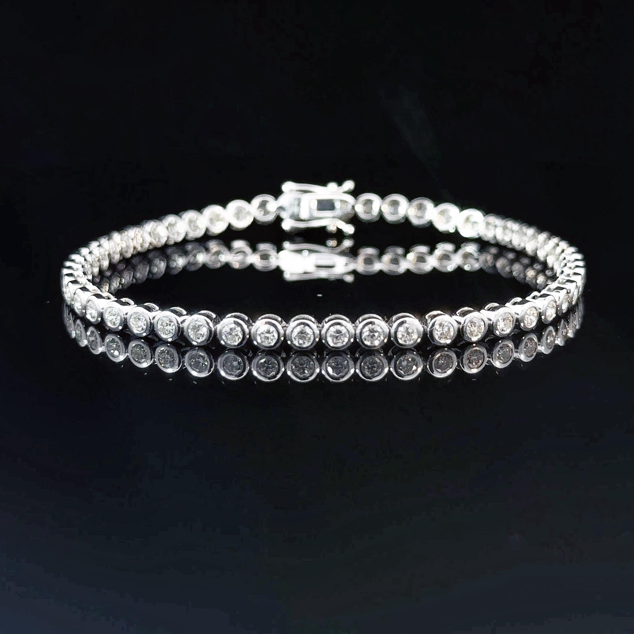 Modern and elegant, this diamond bracelet is part of Xuelai Jewellery London classic lines collection. Composed of a single row of ethically sourced round brilliant diamonds in bezel-setting, their combined weight totals 2.19 carats. Each diamond is