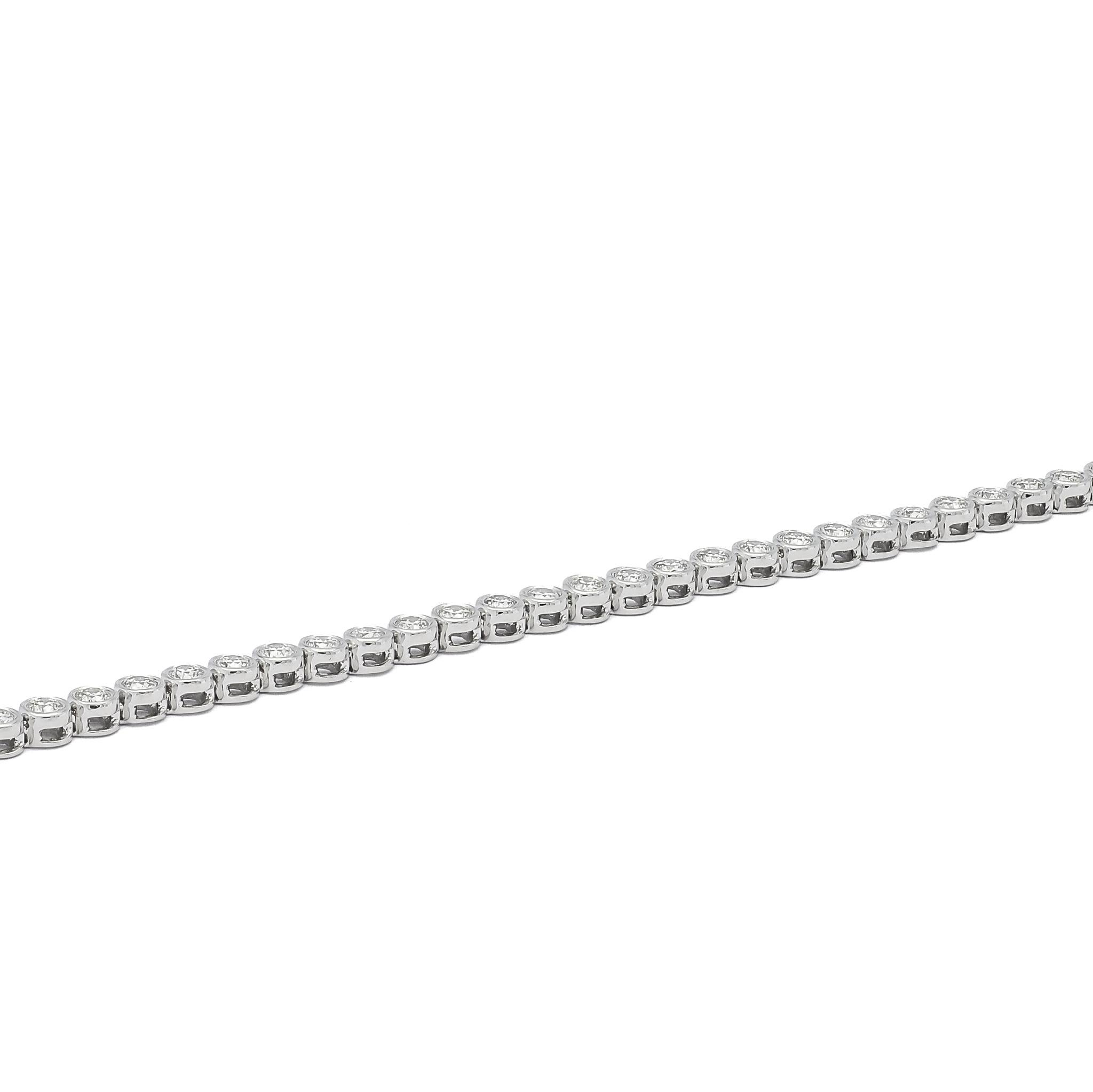 Step into the realm of timeless elegance with this classic bezel-set tennis bracelet. Meticulously crafted in 18K white gold, this exquisite piece showcases the allure of 2.00 carats of natural diamonds. Each diamond is elegantly encased within a