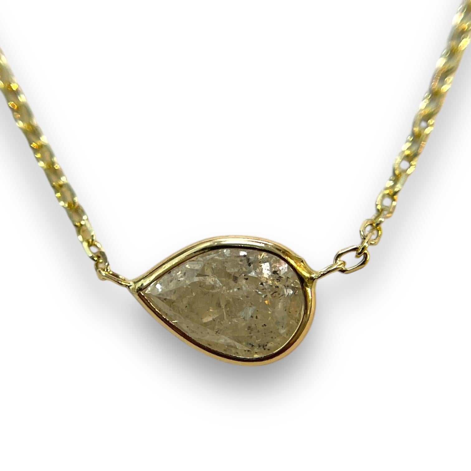 A radiant classic, this necklace features a 1.24ct natural pear diamond, elegantly bezel-set in 14K yellow gold. The adjustable 16-18 inch chain makes it a perfect companion for every wardrobe.