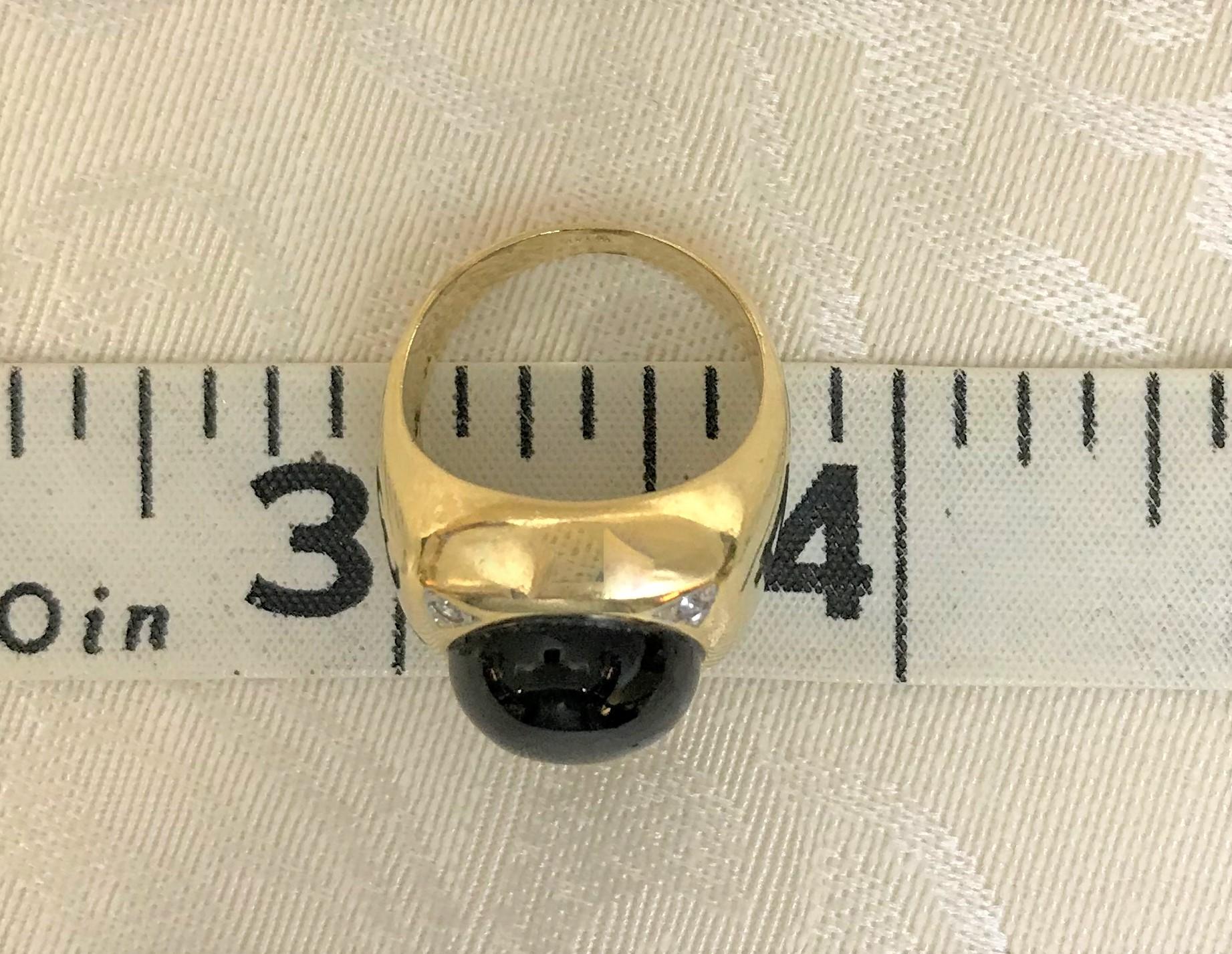 This classic ring will last the test of time and is perfect for man or women!
14 karat yellow gold
Roughly square top of ring, approximately 16.5mm square overall
     Cabochon black onyx stone, approximately 12mm round, set in center of ring
     4