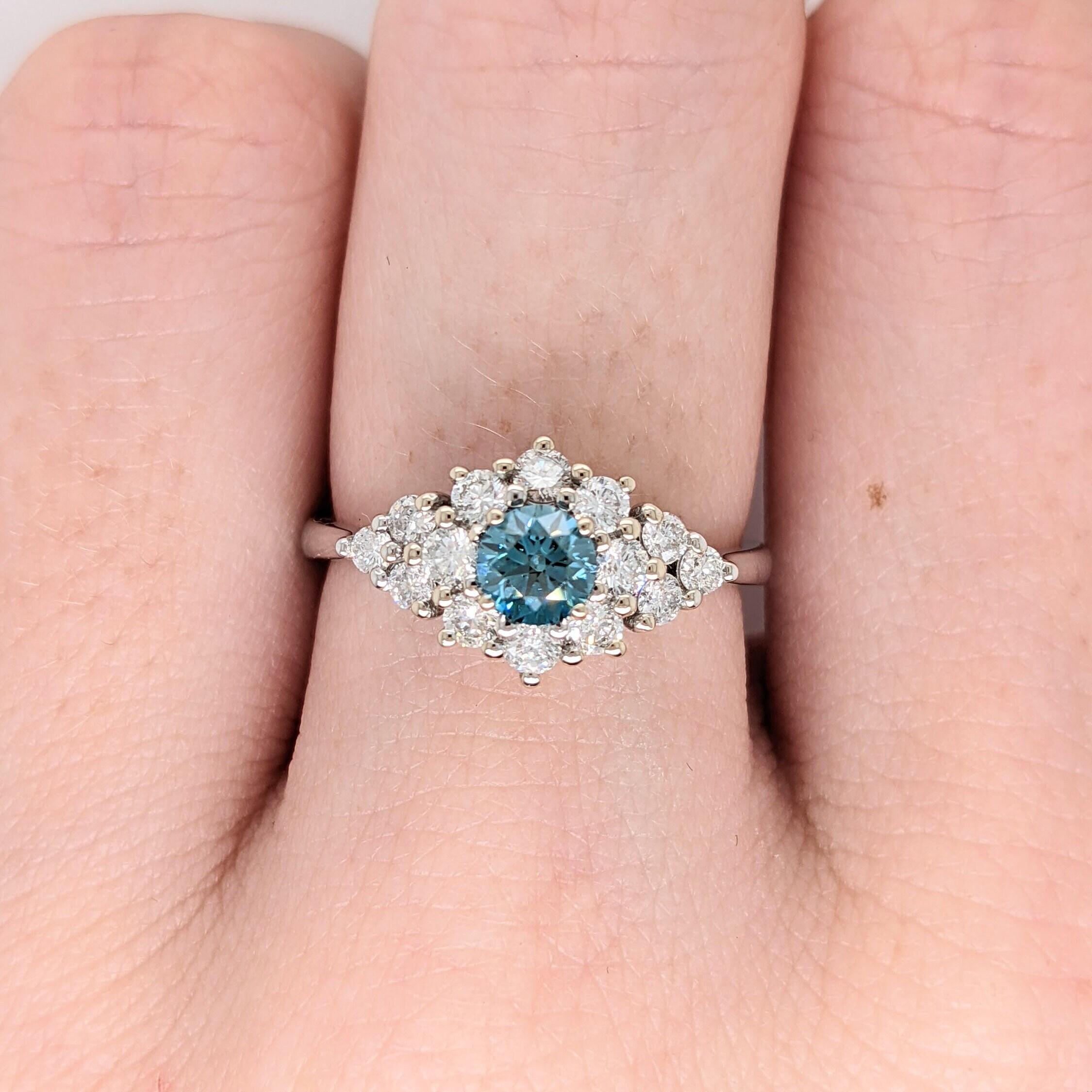 We've set this light Blue diamond with loads of white diamond accents to create the most sparkly and luxurious ring. Diamonds are set in solid 14K gold with strong prongs to allow you be able to wear it worry free daily!

**We offer complimentary