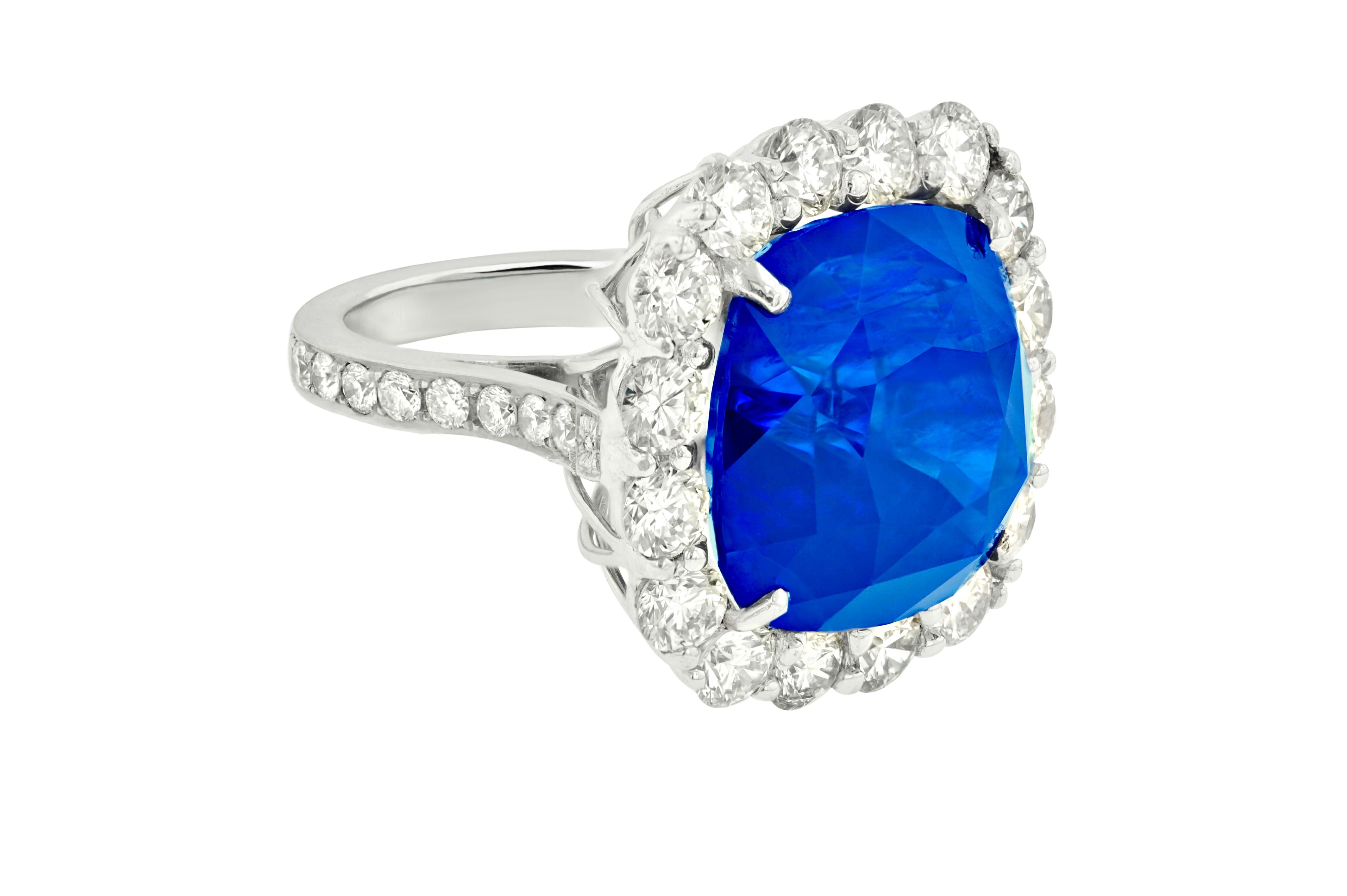 Classic sapphire diamond ring with gia certified sri lanka blue cushion shape sapphire (37.48ct) set with round diamonds (5.35ct) all the way around center and three quarters of the way around the band in platinum setting.
