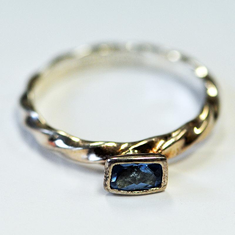 Lovely and delicate with a clear blue rectangular stone. A sterling silver ring by Danish designer Hans Henrik Nygaard, originator of the 'spinning' range of stacking rings.
Perfect for stacking or to wear separately. Measures: 19 mm depth x 5 mm