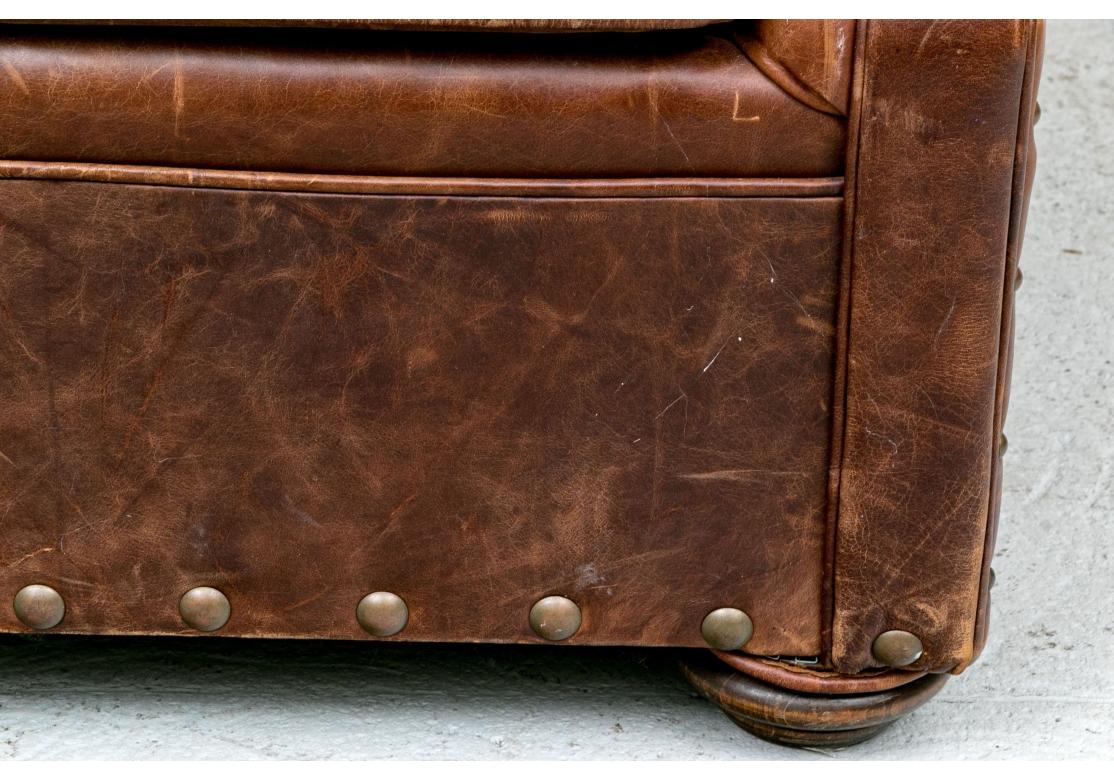Large and incredibly comfortable Vintage Club chair with tufted button-back, rolled flat-panel arms, oversized nail-head base and frame trim and warm butter soft leather with a great age patina. 

Dimensions: 39” wide by 41” deep by 37” high. Seat