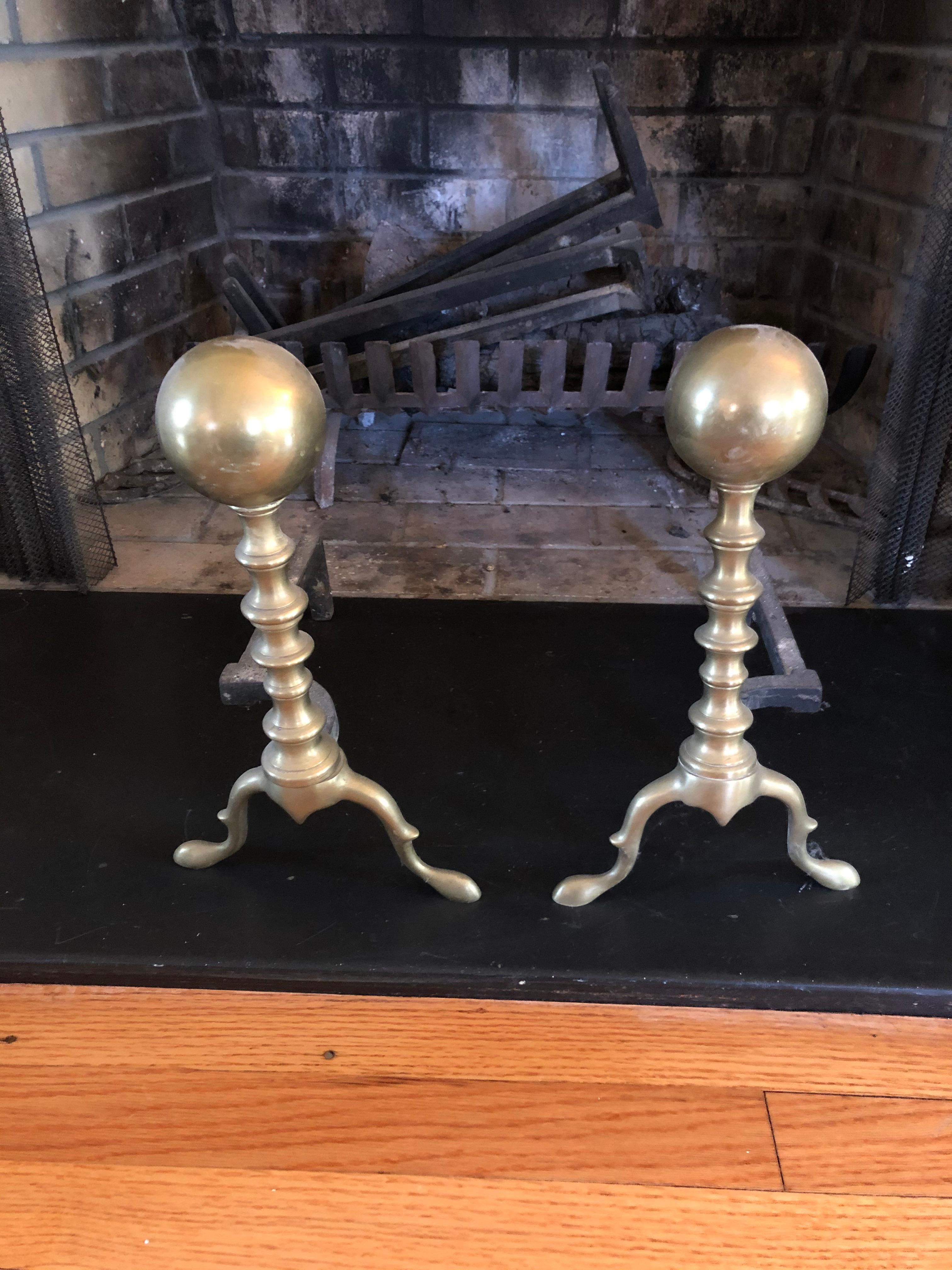 Classic vintage medium sized brass andirons having ball motife.