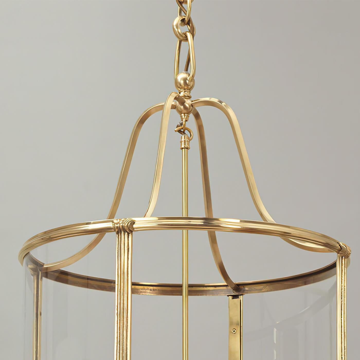 Classic Brass hall lantern and based on a 1940's French design, this hall lantern marries a flowing shape with clean lines. The brass echoes the warmth of the candles while the ribbed frame is highlighted with small pieces of classical